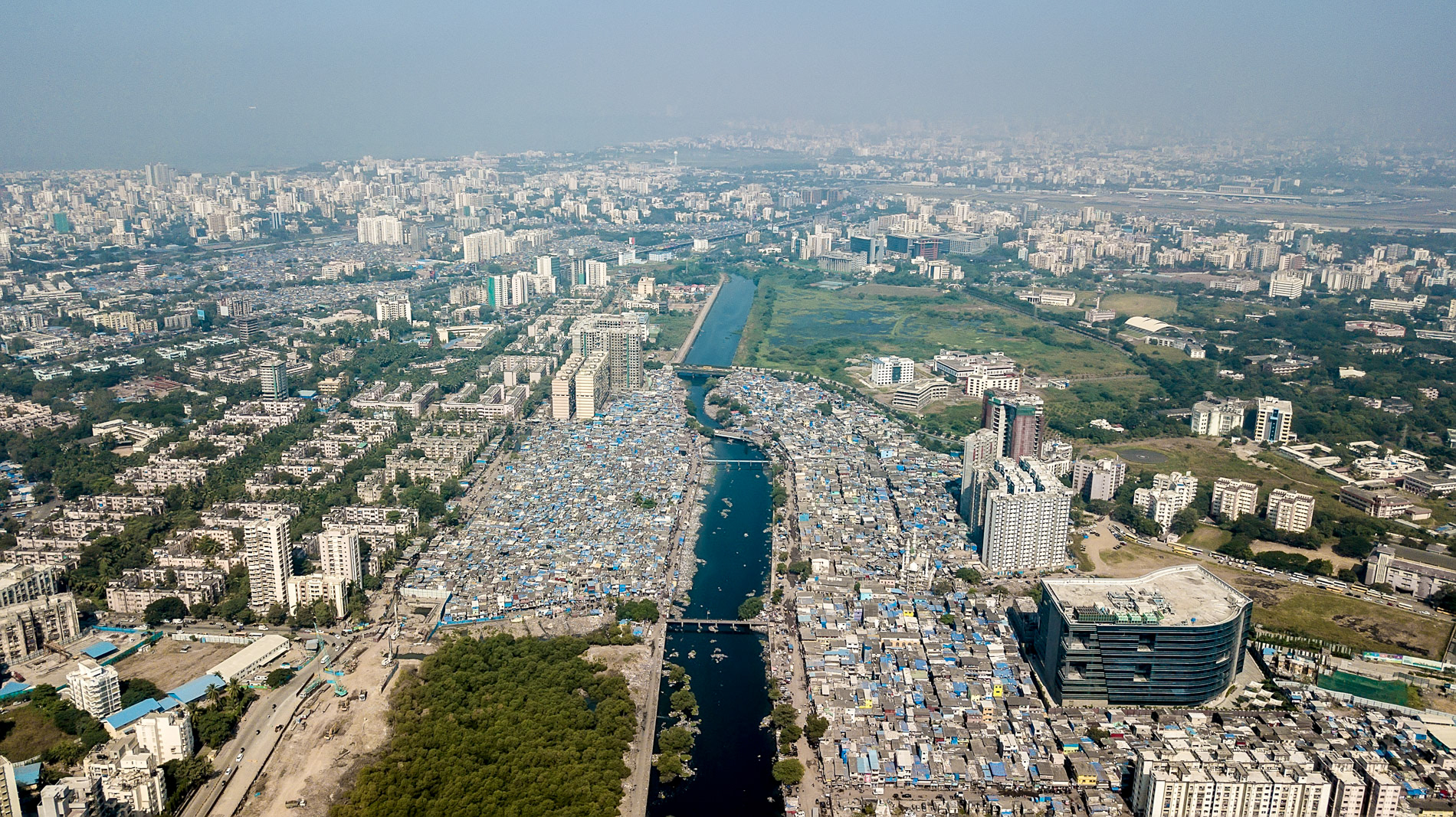 the mithi river with slums, mumbai india