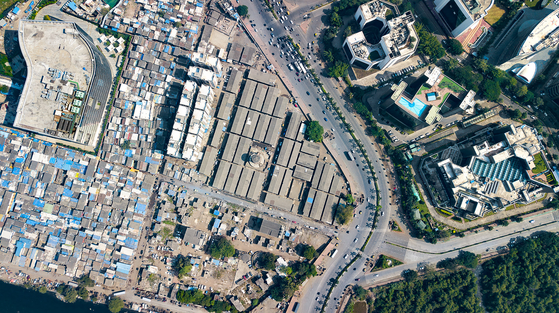 Drone image of the National Stock Exchange of India facing a sprawling informal settlement.