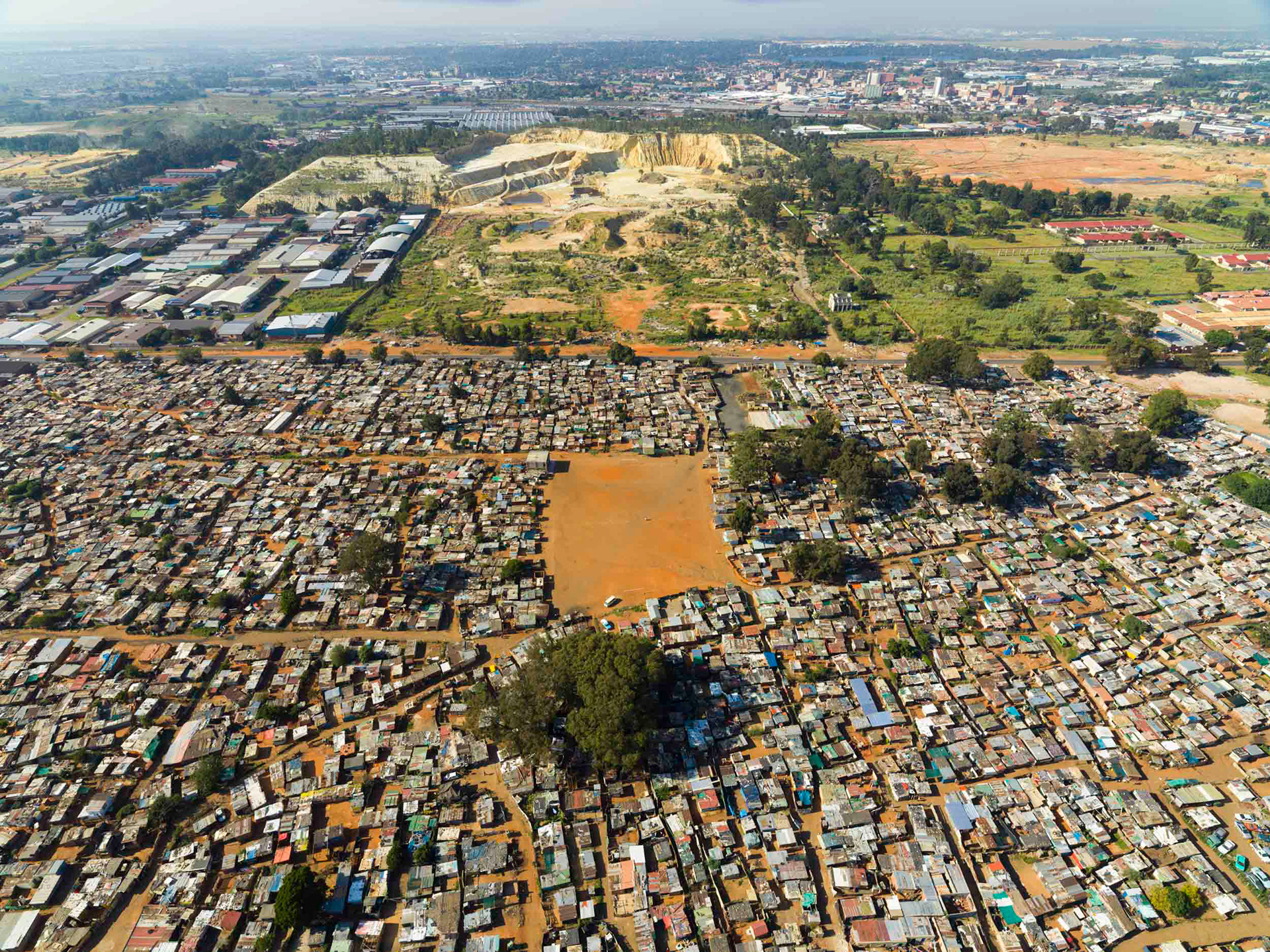 aerial view of shacks and gold mine in johannesburg