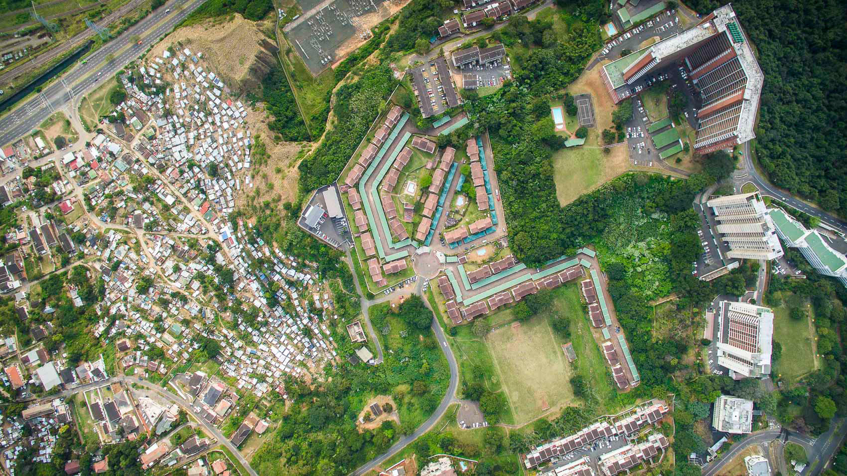 aerial view of shacks and apartment buildings in durban