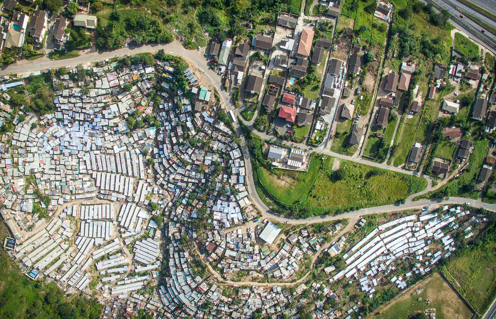 aerial view of shacks and apartment buildings in durban
