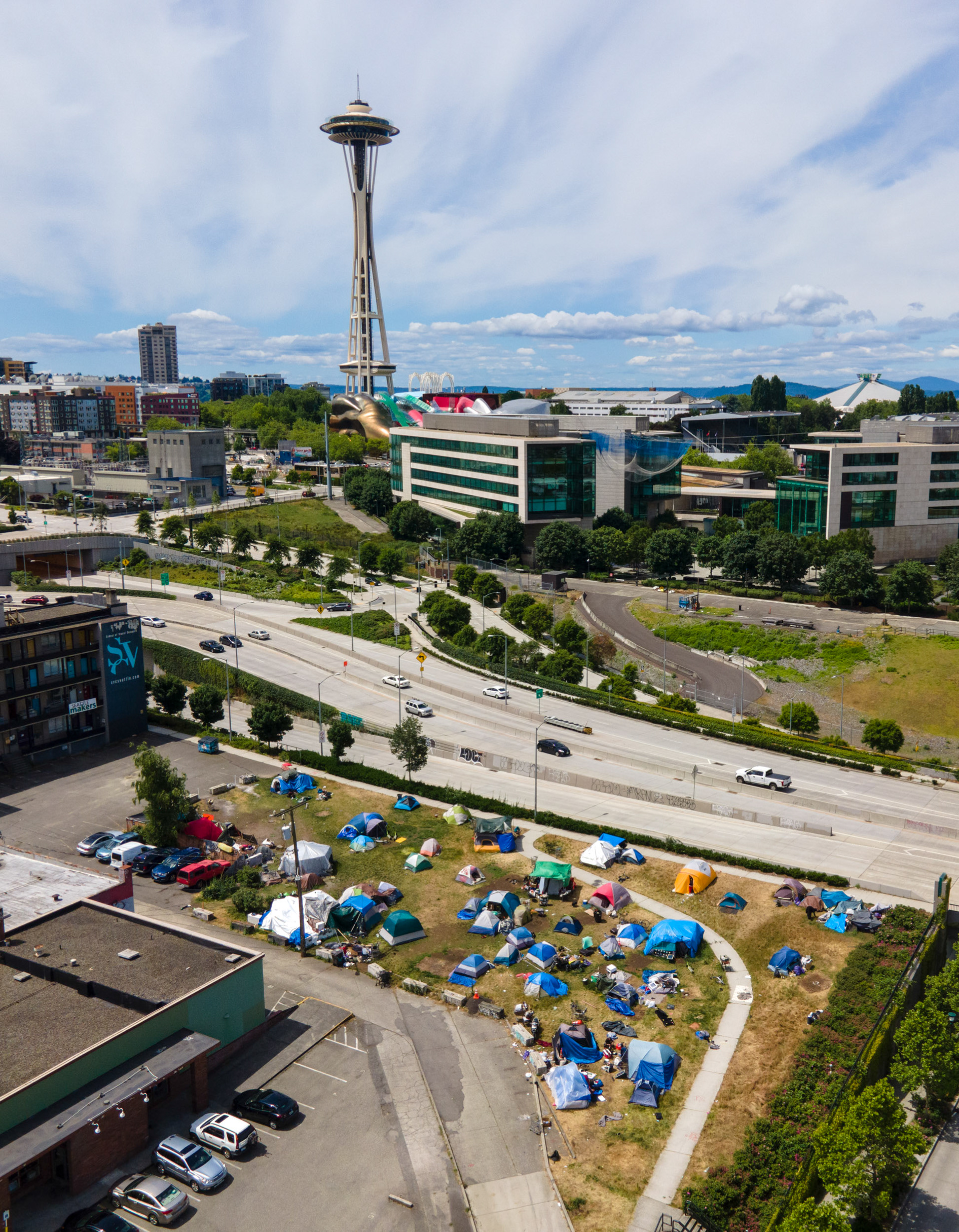 an aerial view of a homeless tent city next to the space needle in seattle