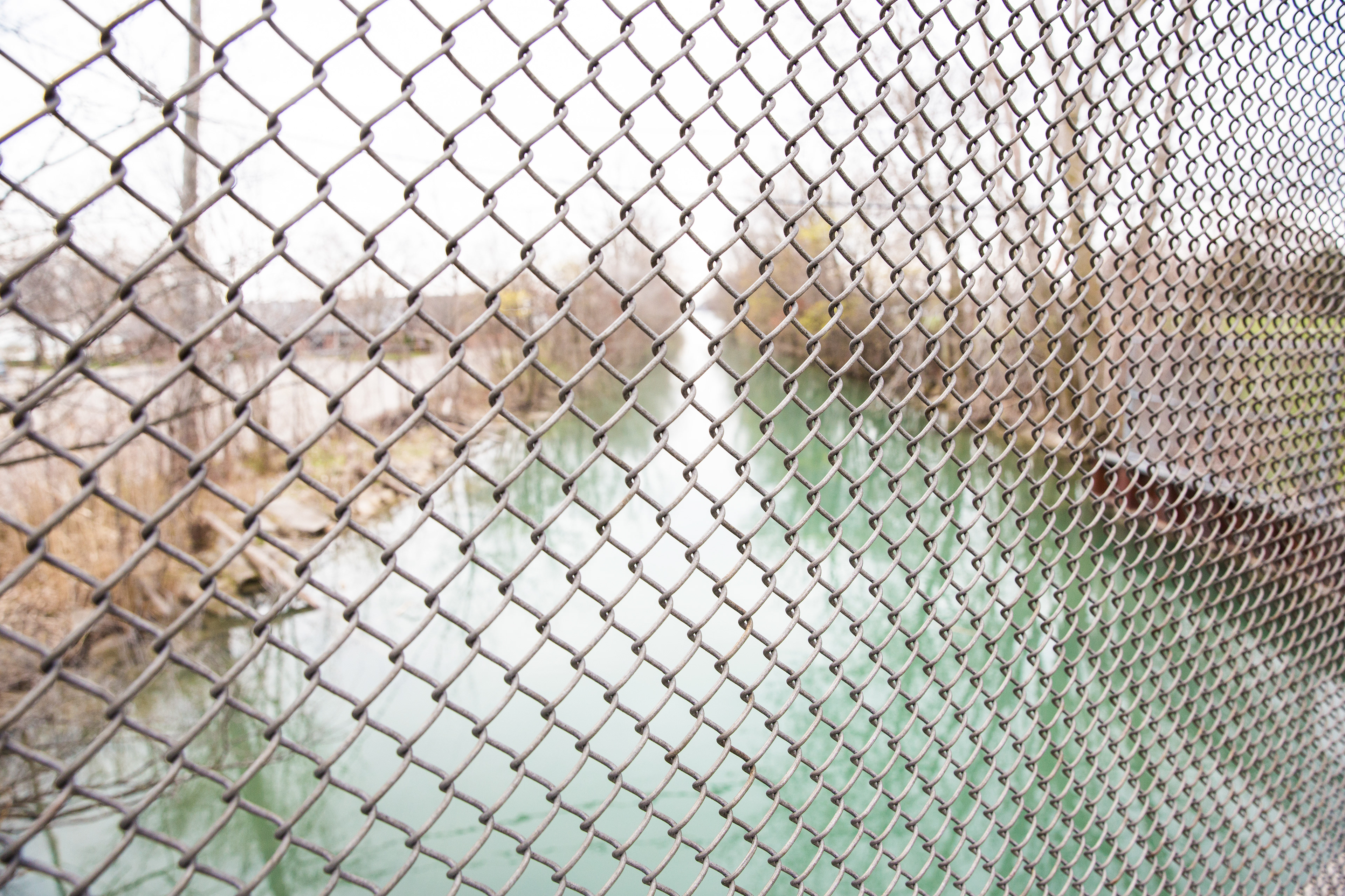 chain link fence over a canal, detroit