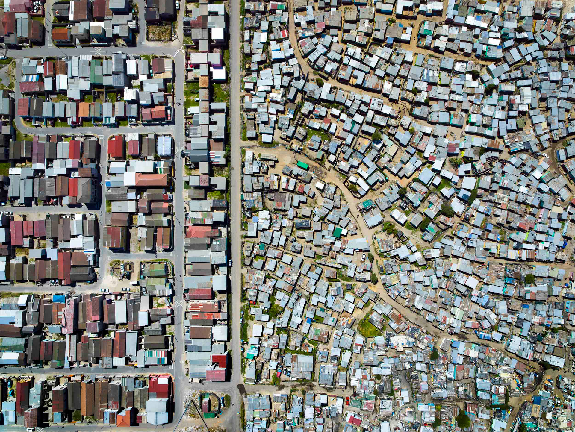 shacks next to houses in cape town south africa