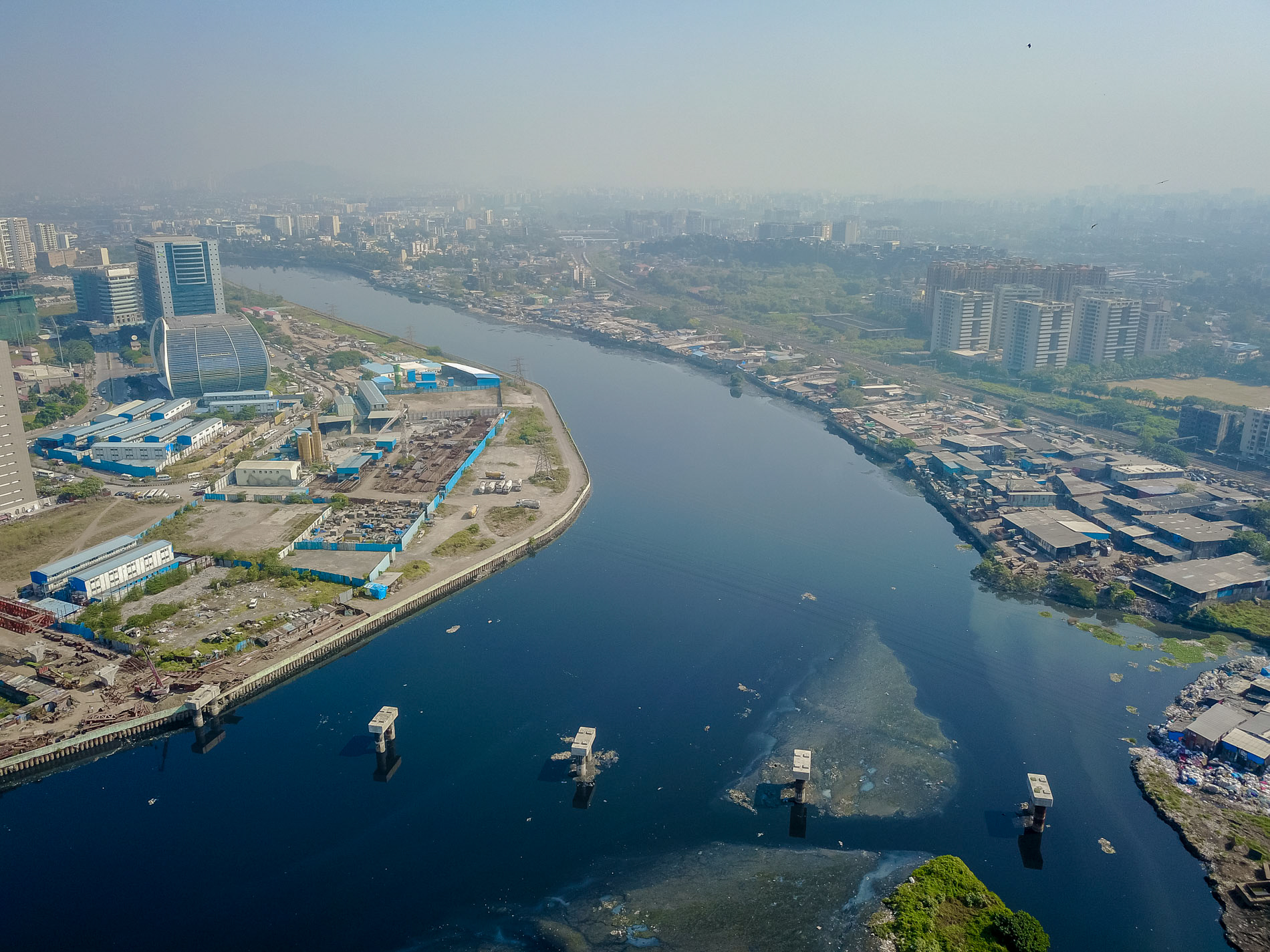 a bridge connecting a slum and a wealthy area mithi river mumbai