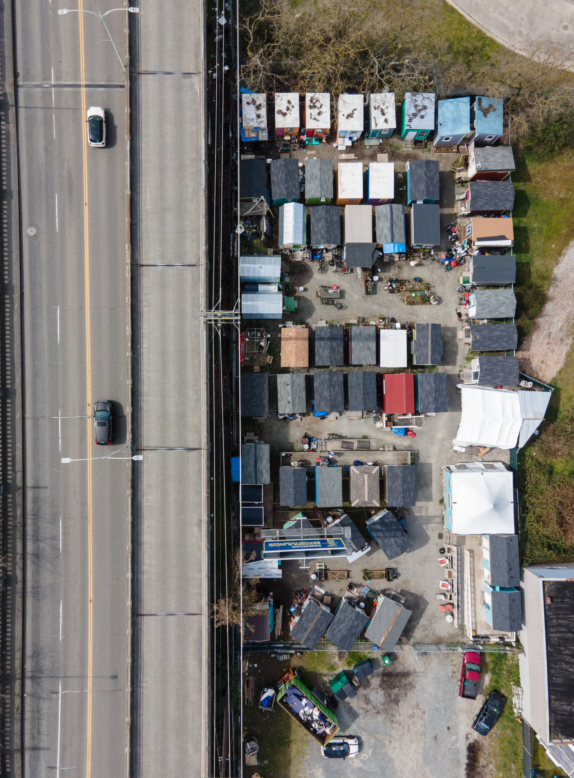 aerial view of a homeless camp next to a bridge in seattle