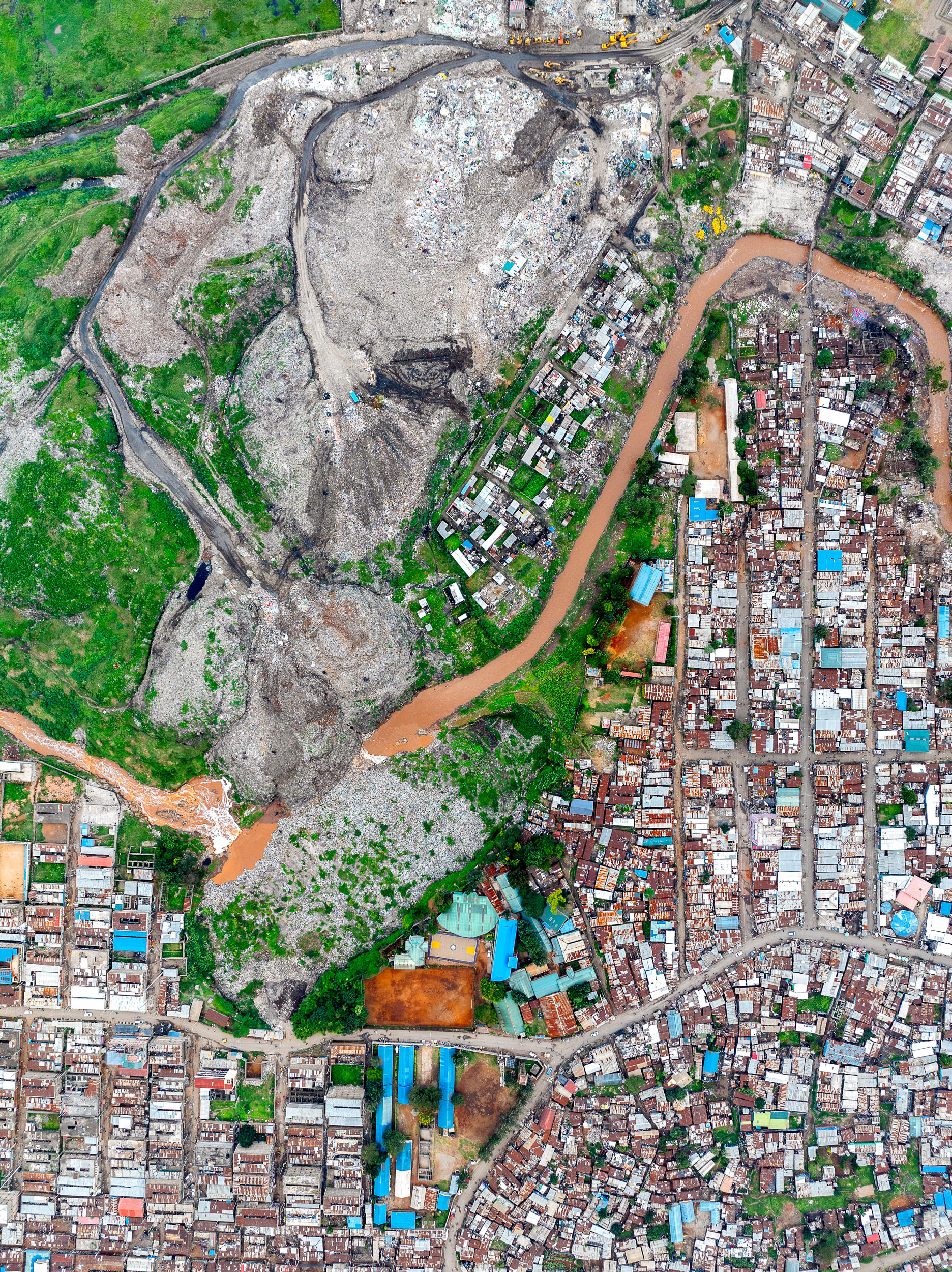 Drone view of Dandora dumpsite adjacent to Nairobi slums, illustrating environmental and spatial inequality.