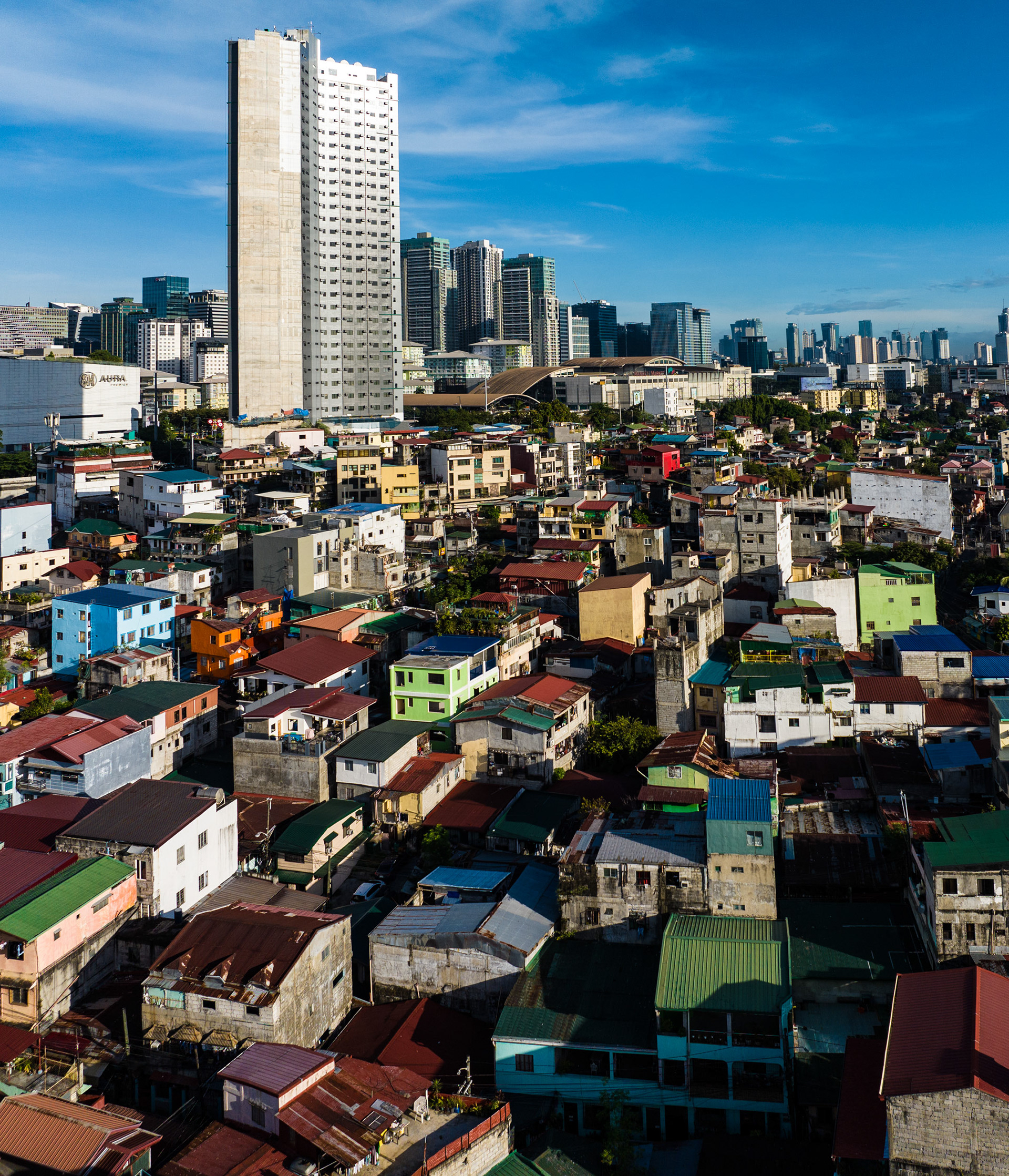 Contrast between Pembo’s crowded housing and BGC’s high-rises highlights wealth disparity in Manila.