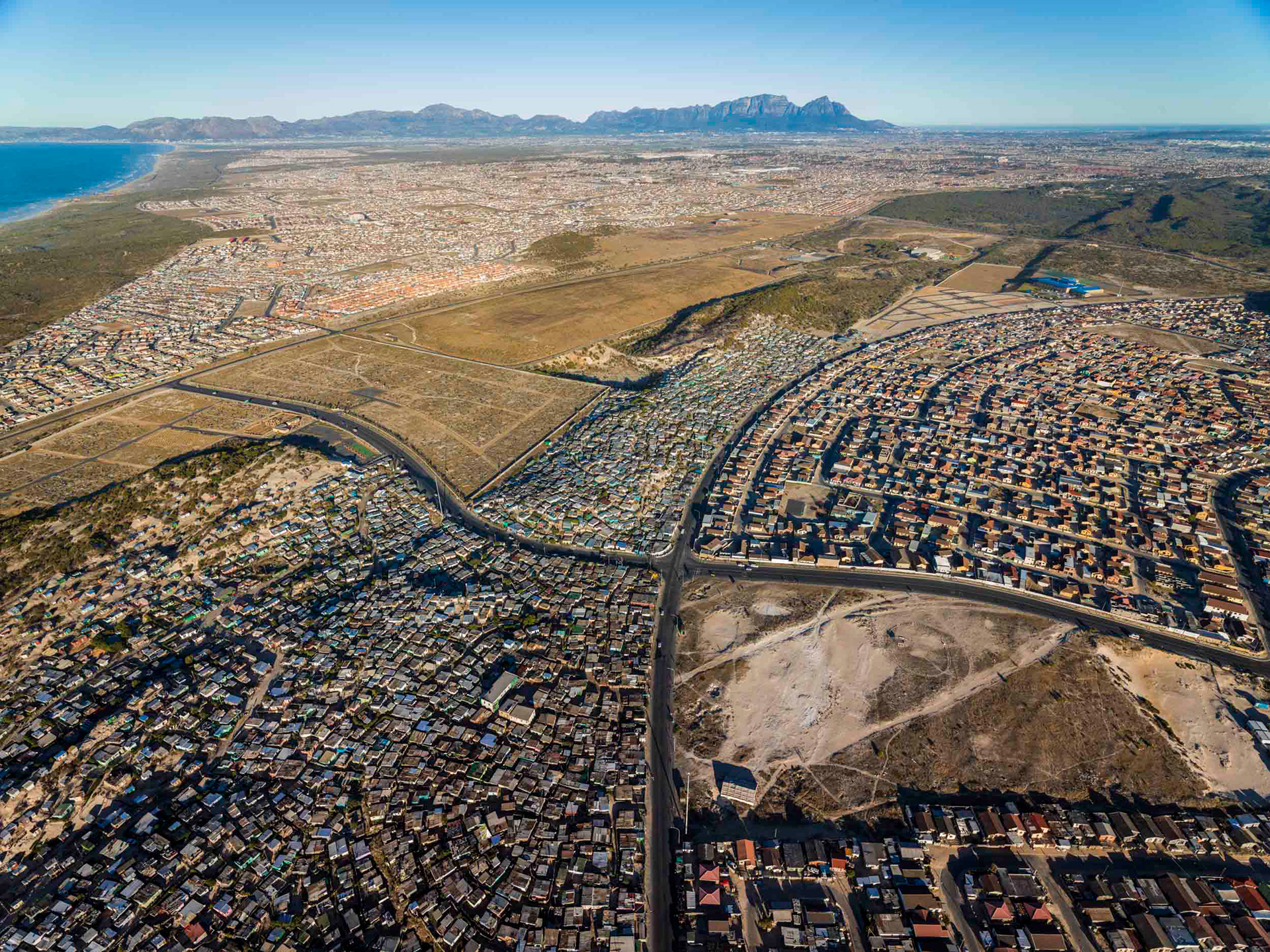 aerial view of shacks and mountain and ocean in cape town