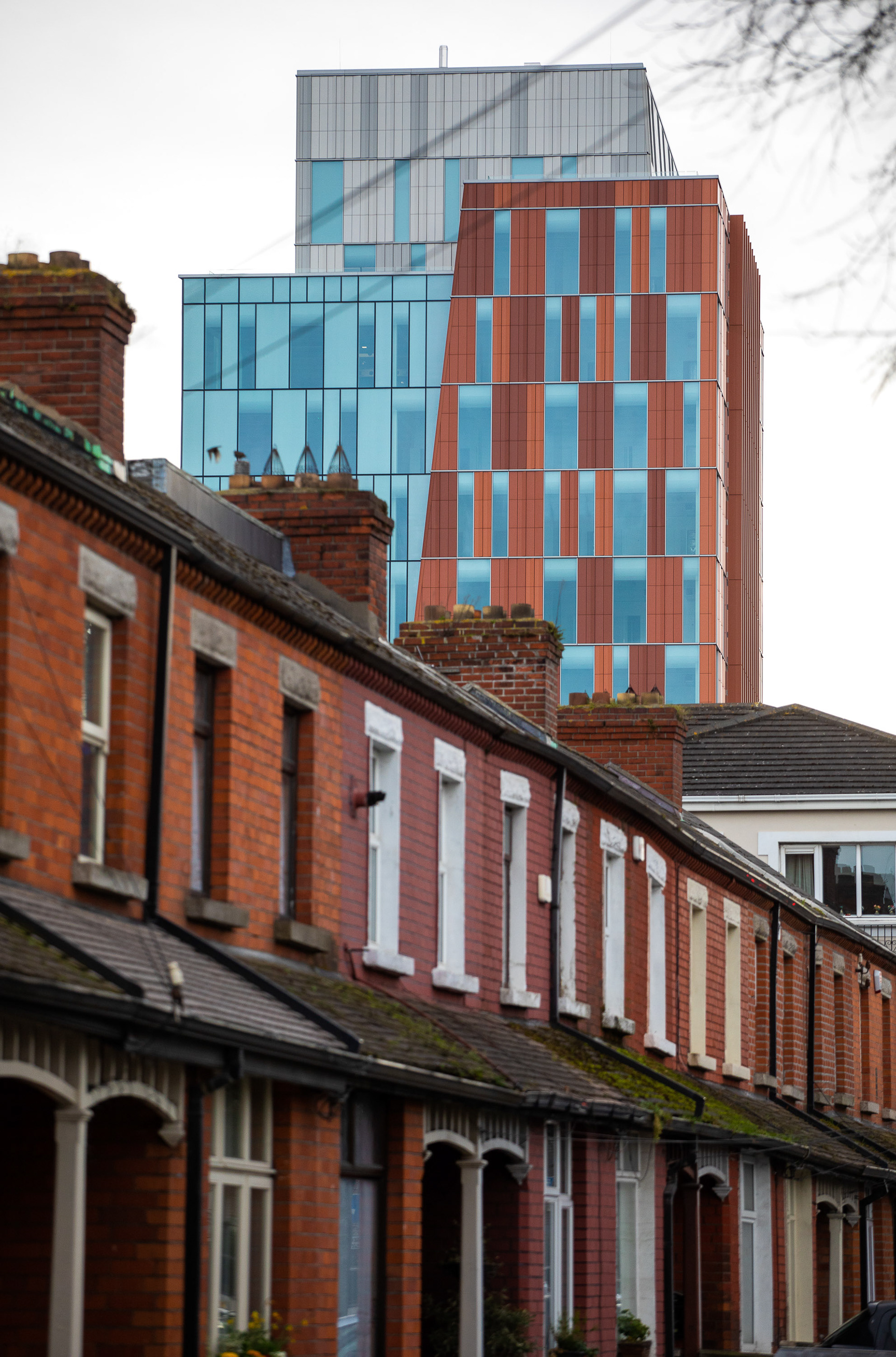 Old homes in front of new glass skyscraper in Dublin, Ireland
