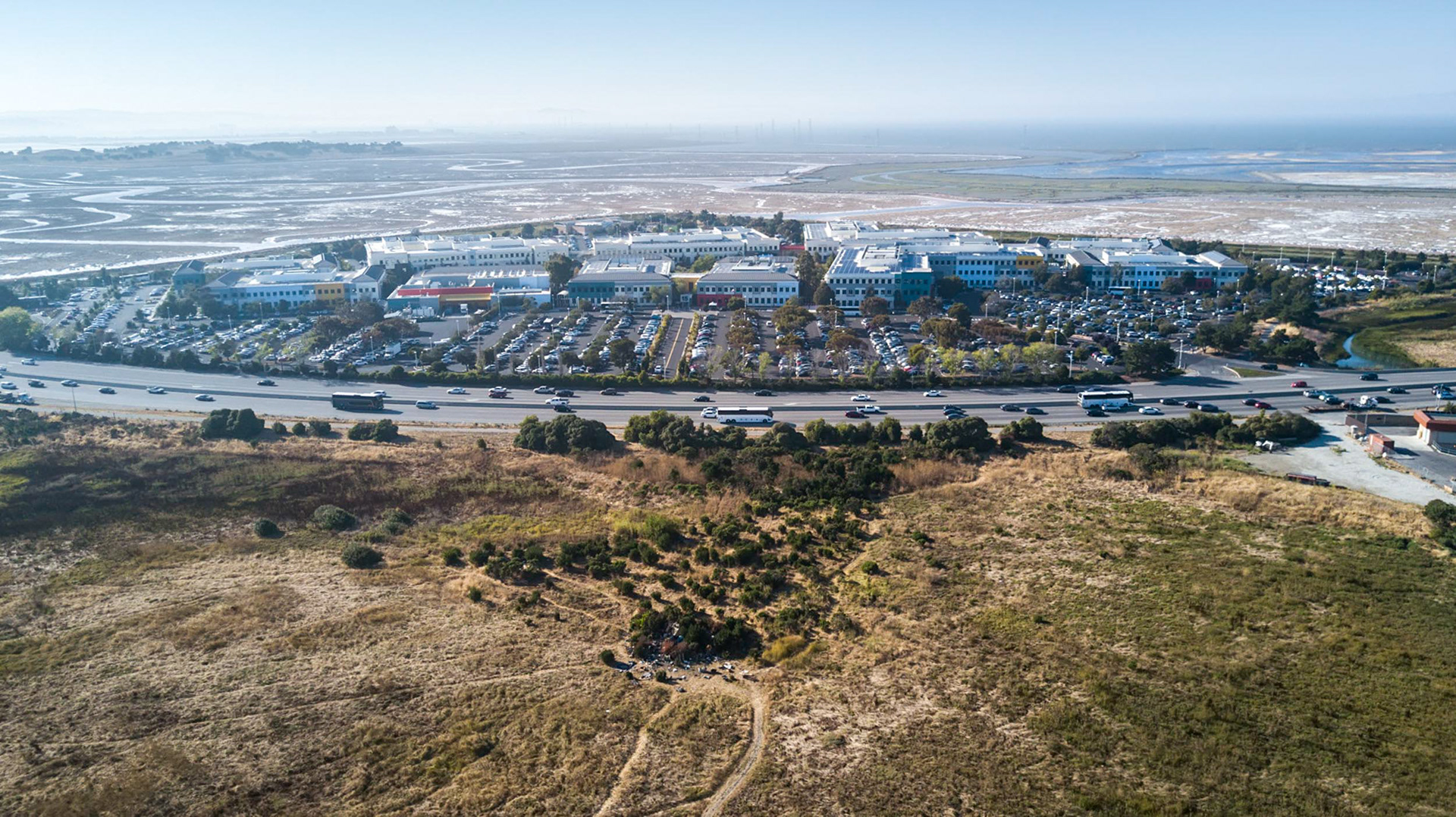 aerial view of a homeless tent city next to facebook headquarters