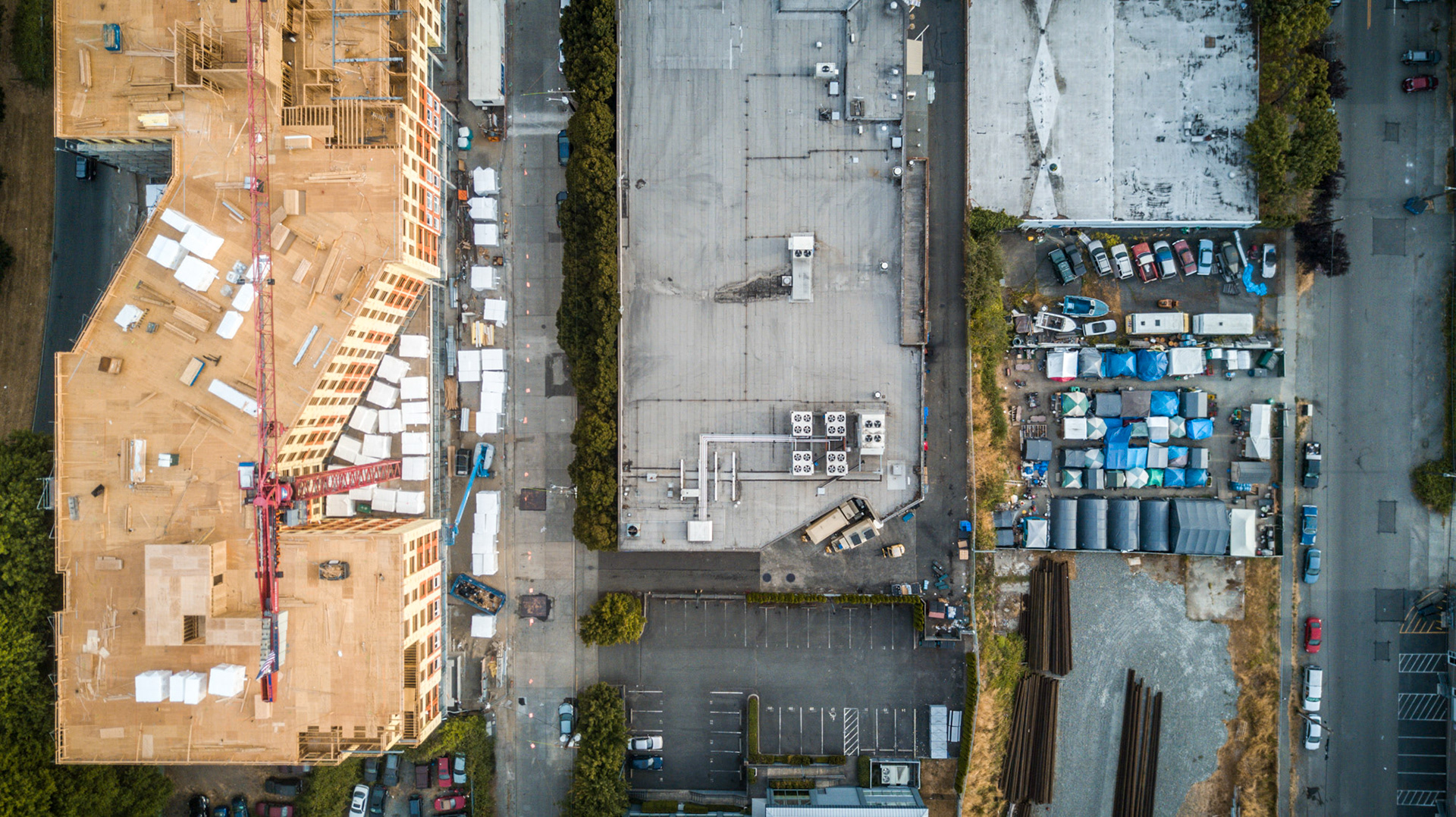 aerial view of a homeless camp next to construction in seattle