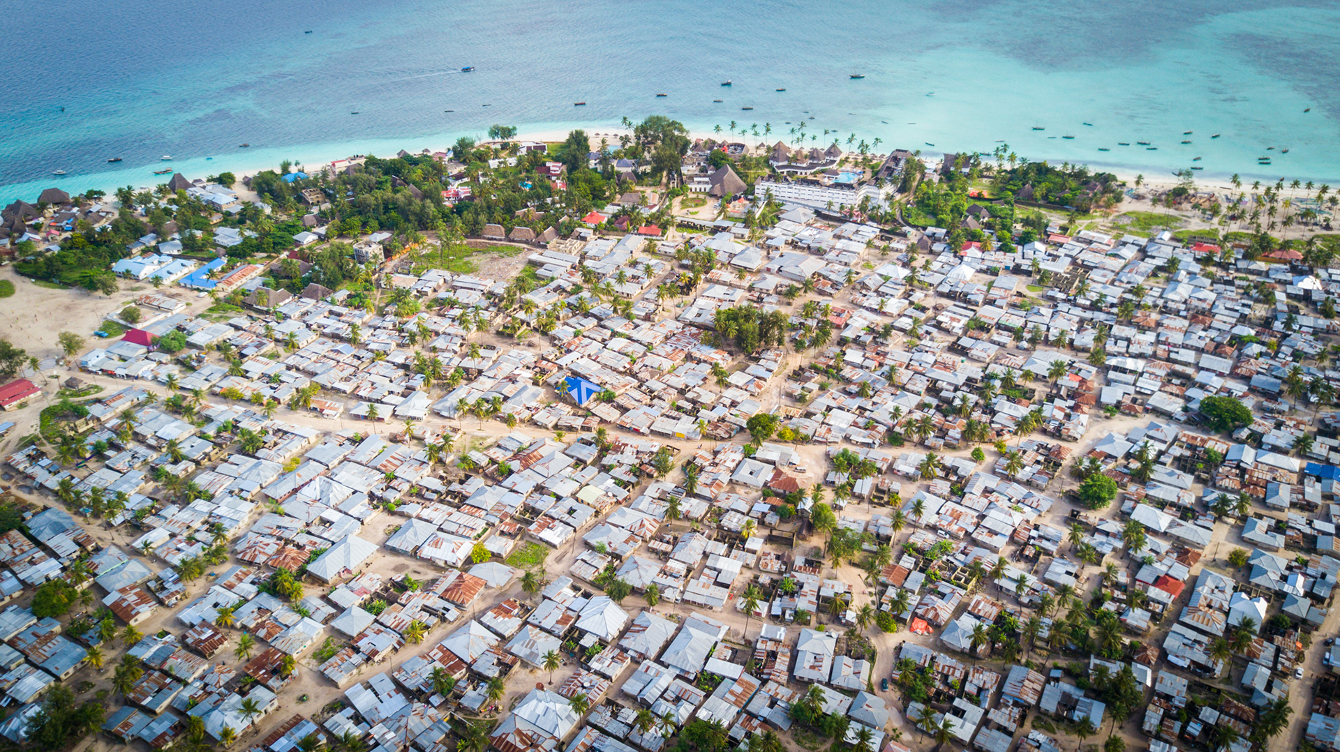aerial view of expensive hotel with slums in zanzibar