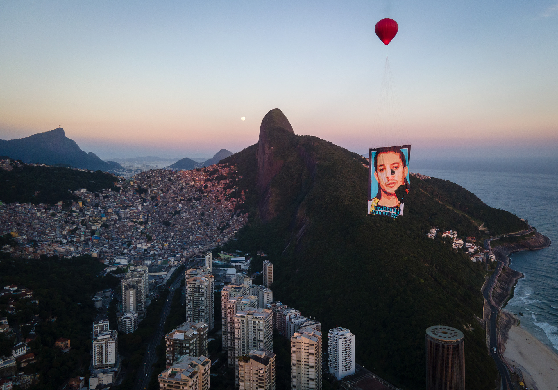Balloon carrying a memorial portrait floats above Rocinha favela in Rio, part of a local mourning ritual for the Rocinha favela.
