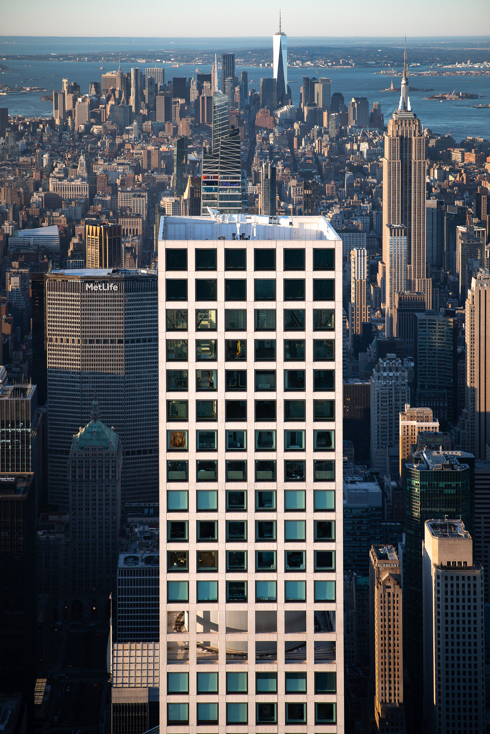 An aerial view of Manhattan with many large buildings, looking south toward the World Trade Center.