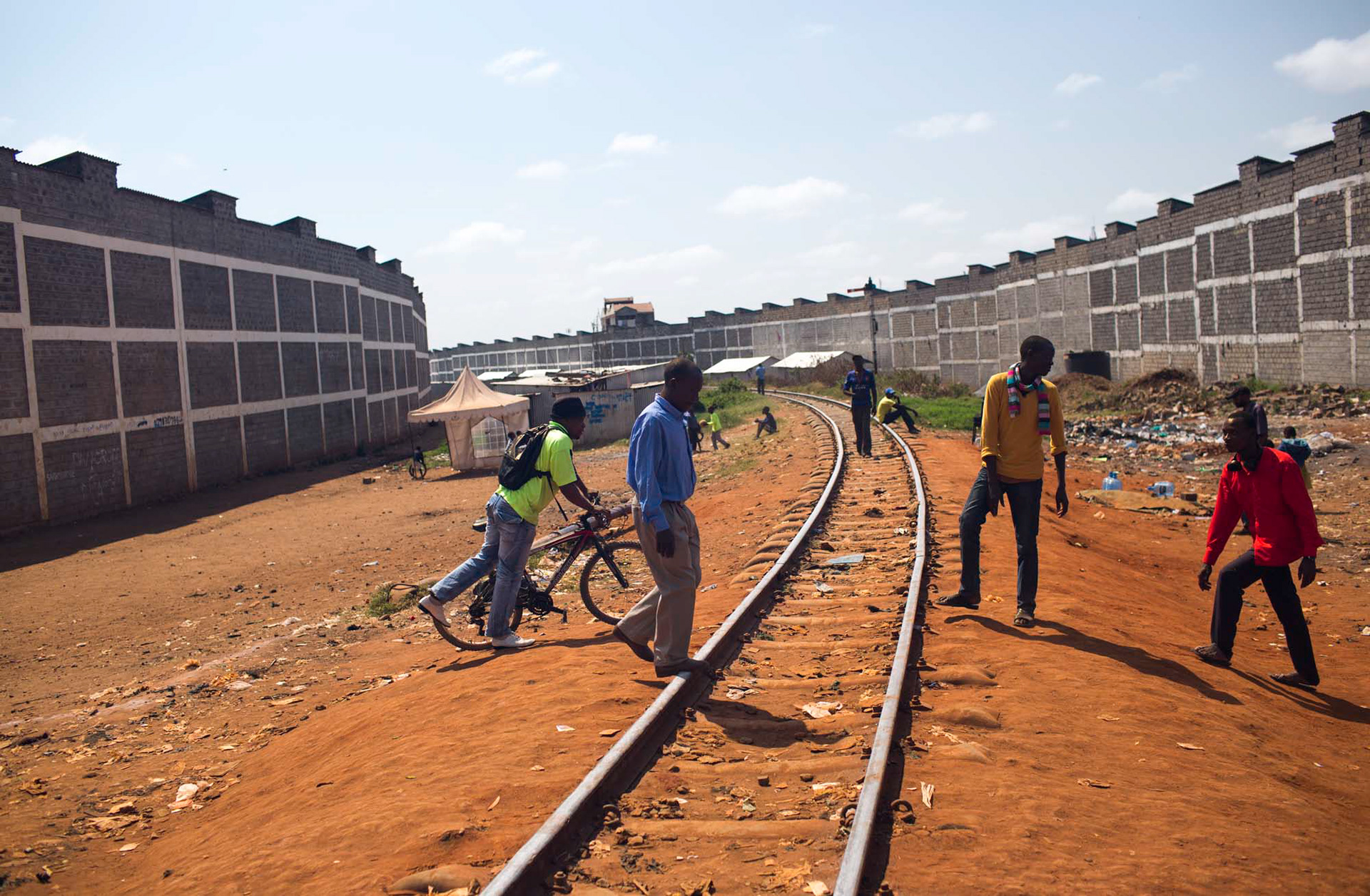 men crossing train tracks in nairobi