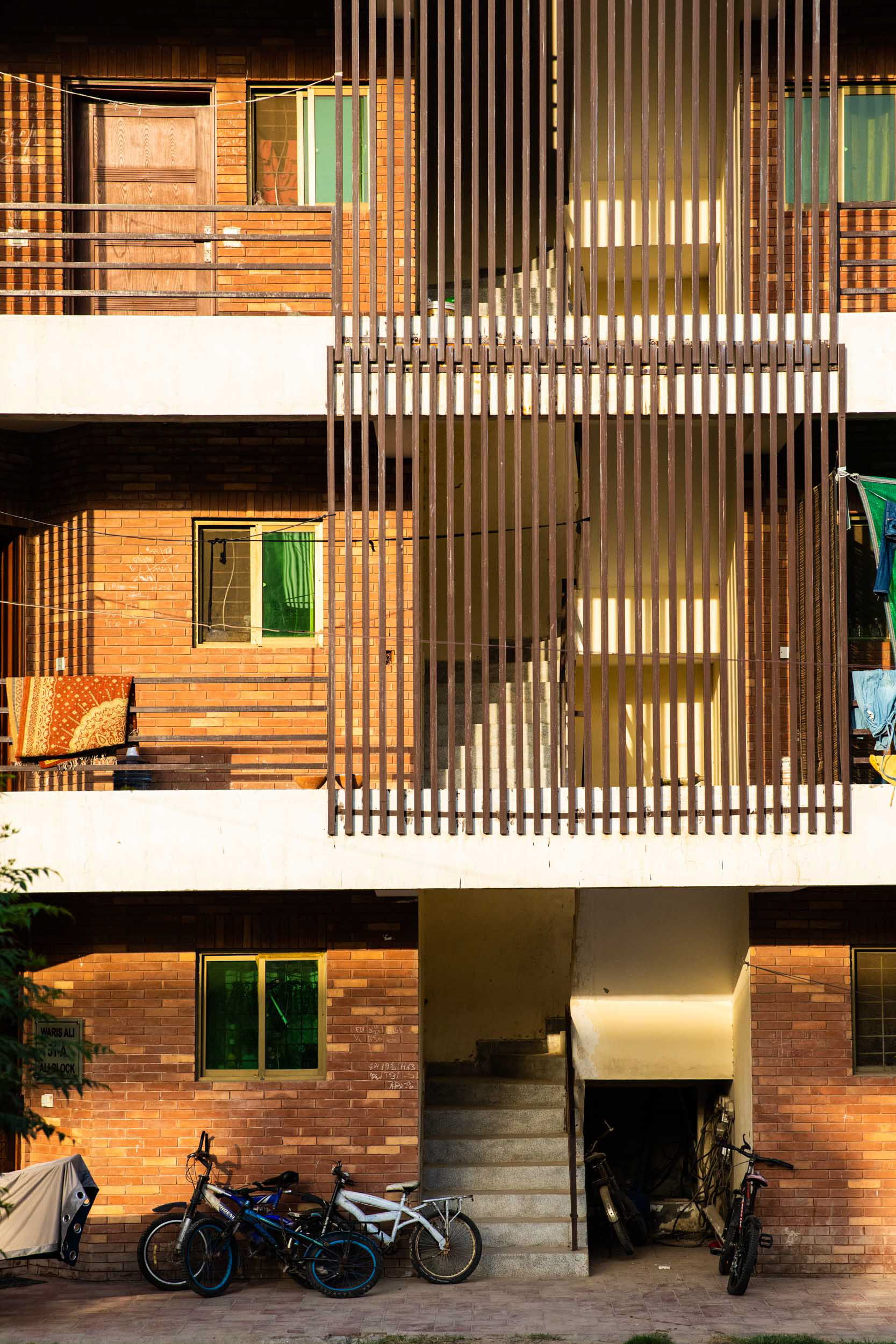 An apartment building facade in the setting sun.