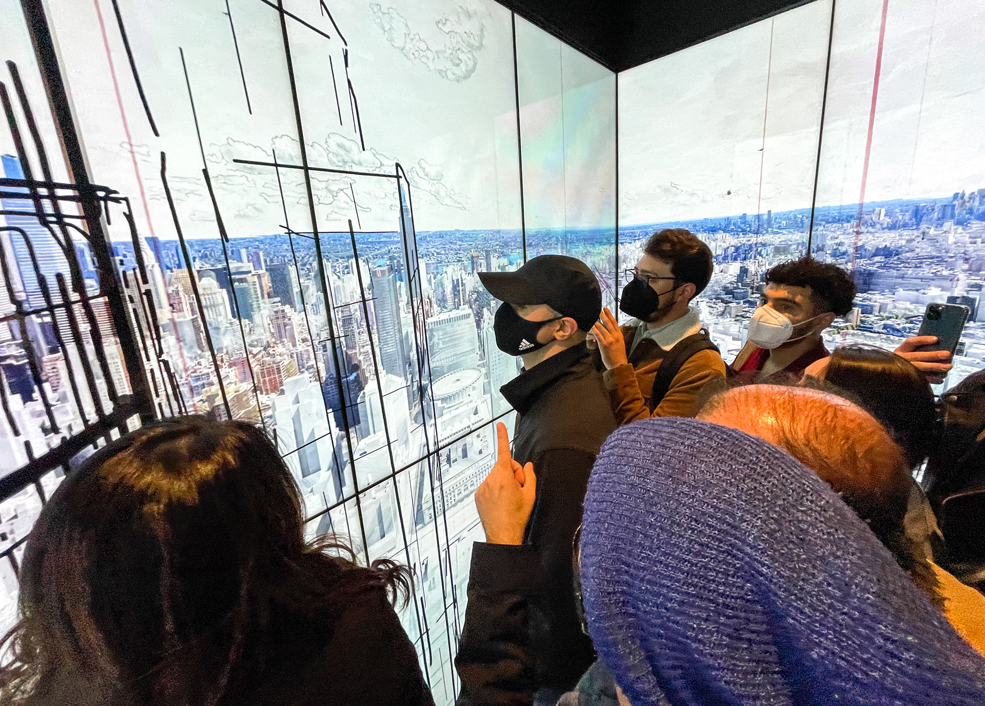 People looking at LED panels in an elevator.
