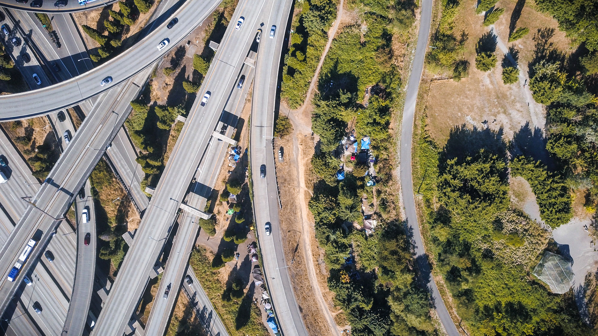 aerial view of a homeless camp with highway in seattle