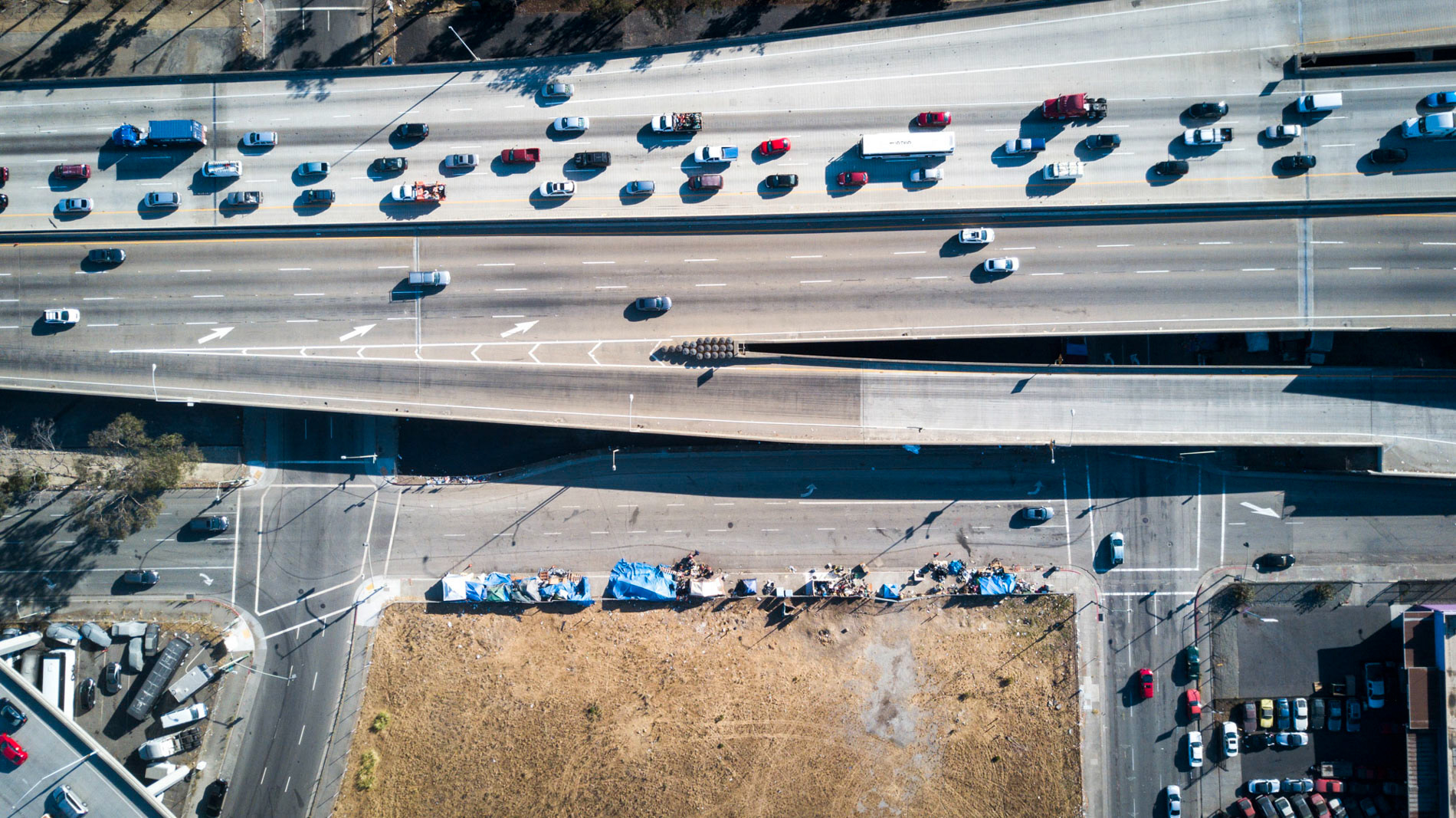 aerial view of highways and homeless tents in oakland