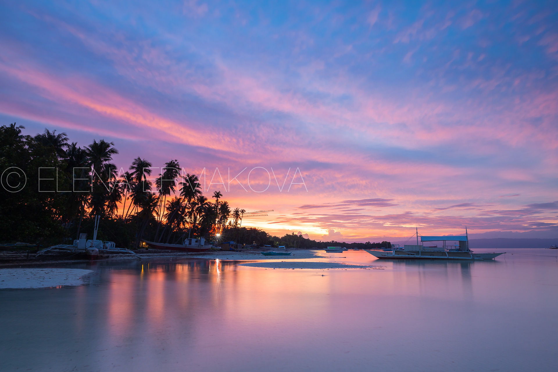 Sunset view of the Dolho Beach with traditional bangka boat, Panglao, Bohol, Philippines