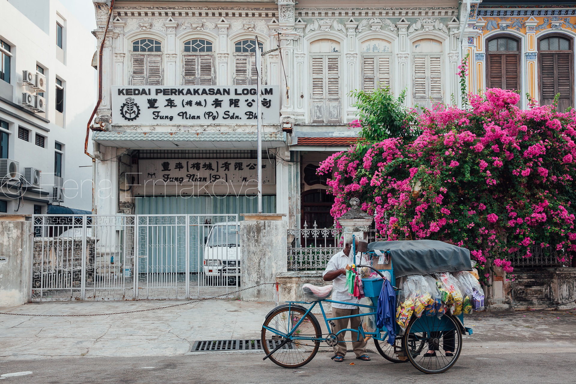 Vendor is selling snacks from the tricycle in George Town, Penang, Malaysia. Travel photography by Elena Ermakova.