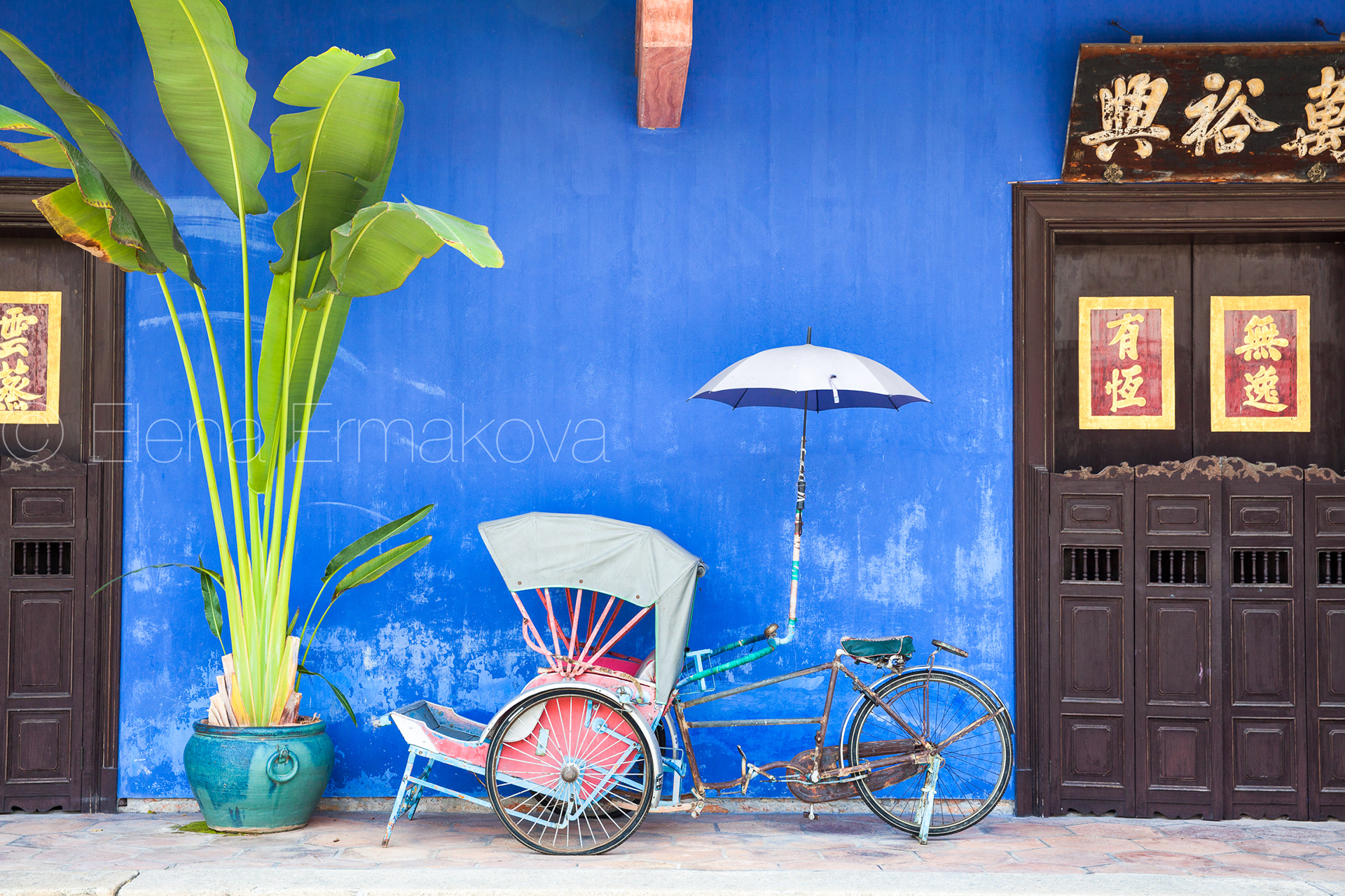 Old rickshaw tricycle near Fatt Tze Mansion or Blue Mansion, famous oriental historical building in George Town, Penang, Malaysia. Travel photography by Elena Ermakova.