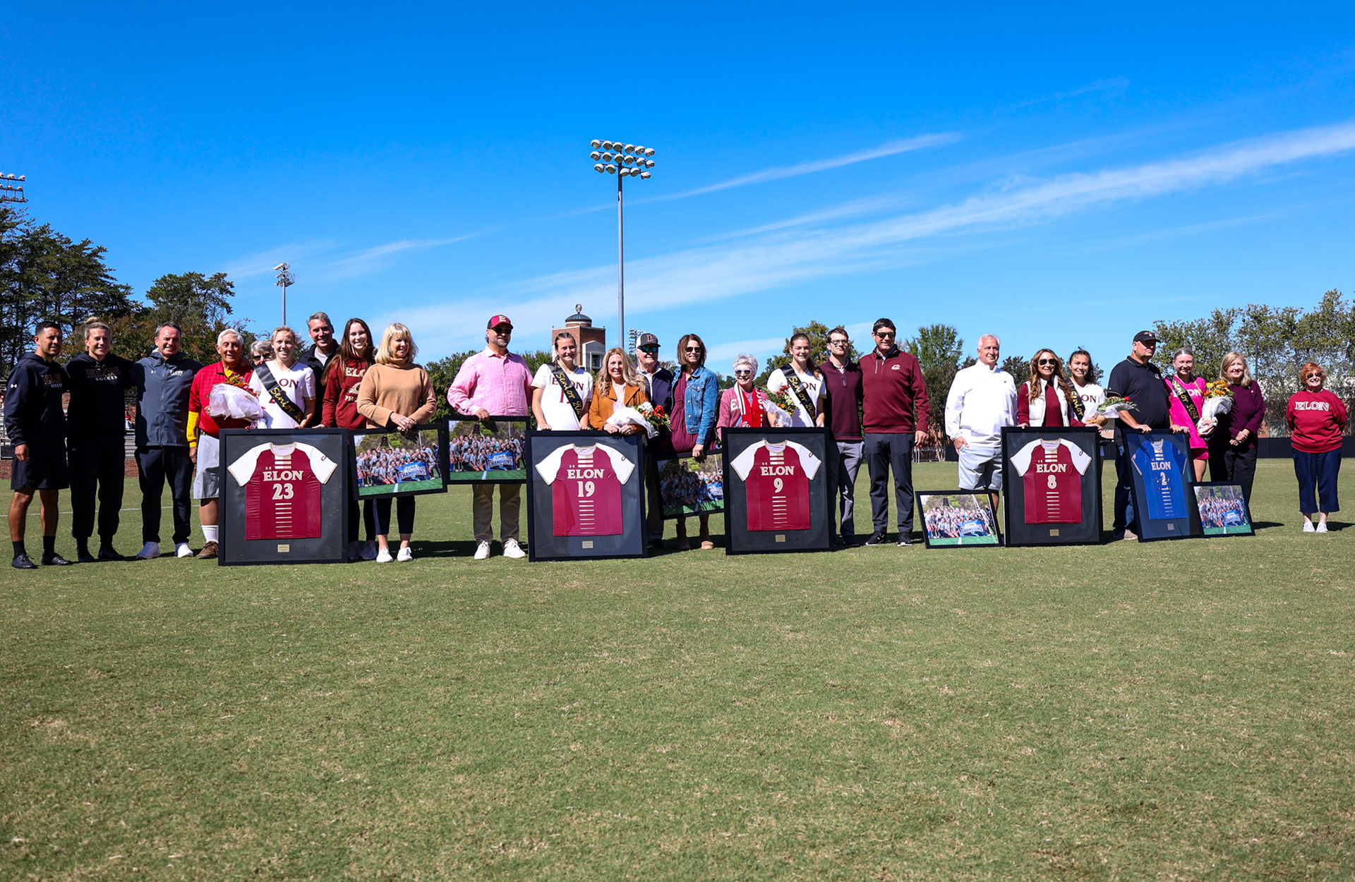 The five Elon seniors and their families pose for a group picture on Rudd Field during the Senior Day ceremony on Oct. 8, 2023. Photo by Jacob Kisamore.