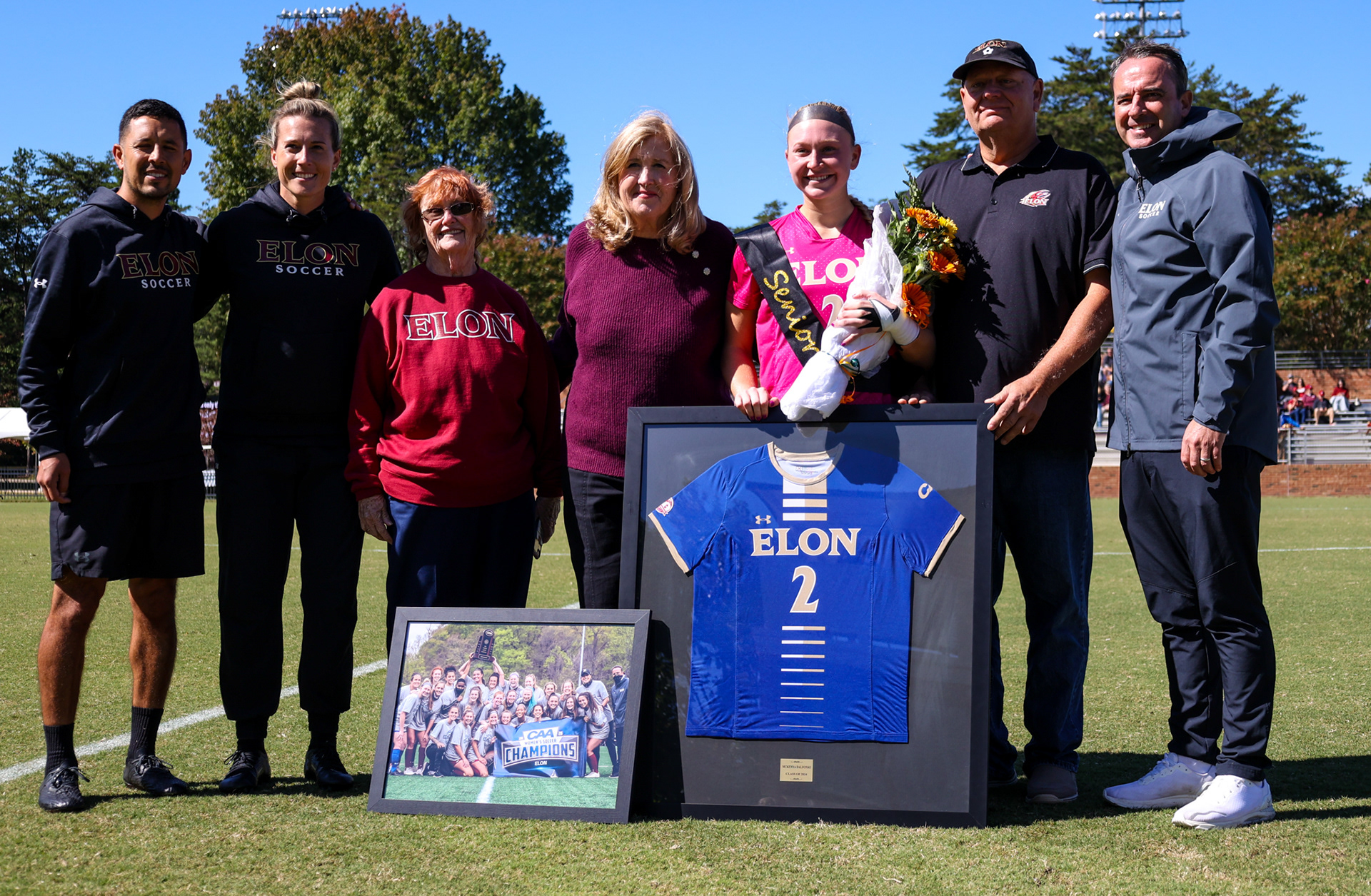 Senior McKenna Dalfonso poses with her family for a photo on Rudd Field during Elon’s Senior Day ceremony on Oct. 8, 2023. Photo by Jacob Kisamore.