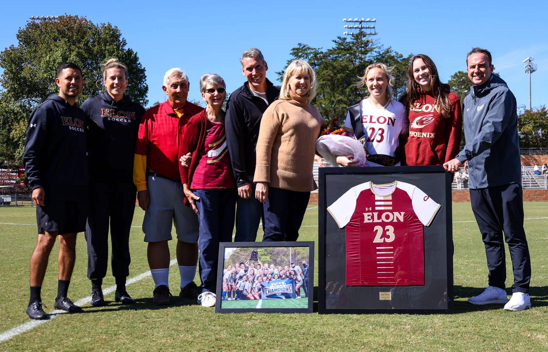Senior Kerri Coffman poses for a photo with her family on Rudd Field during Elon’s Senior Day ceremony on Oct. 8, 2023. Photo by Jacob Kisamore.