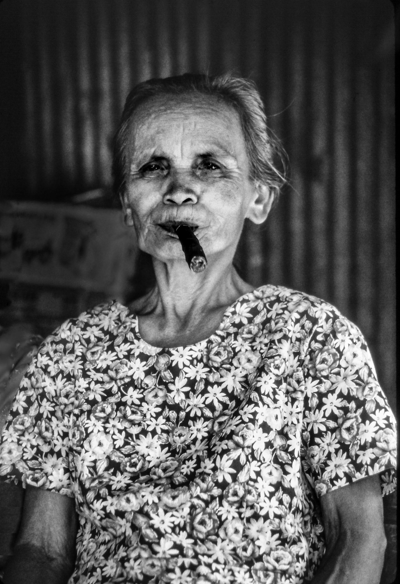 I took this in the Philippines in a village where the elderly ladies make sell and smoke cigars. She has so much dignity and defiance in her face