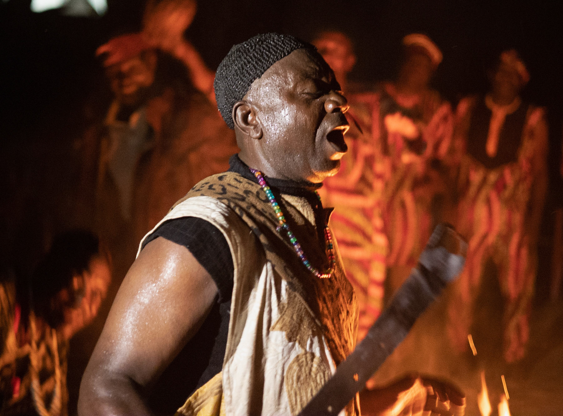 Kanaa - Cultural Ceremony man singing and dancing with traditional sword ritual, Cameroon 2022
