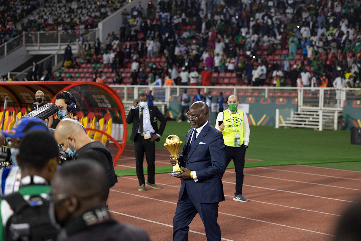 Cameroon legend Roger Milla, carrying AFCON trophy - AFCON 2022 - Yaounde