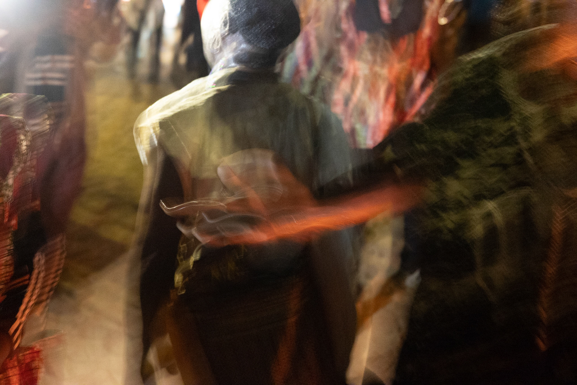 Kanaa - Cultural Ceremony man singing and dancing with traditional sword ritual, Cameroon 2022 - Hand motion during group dance.