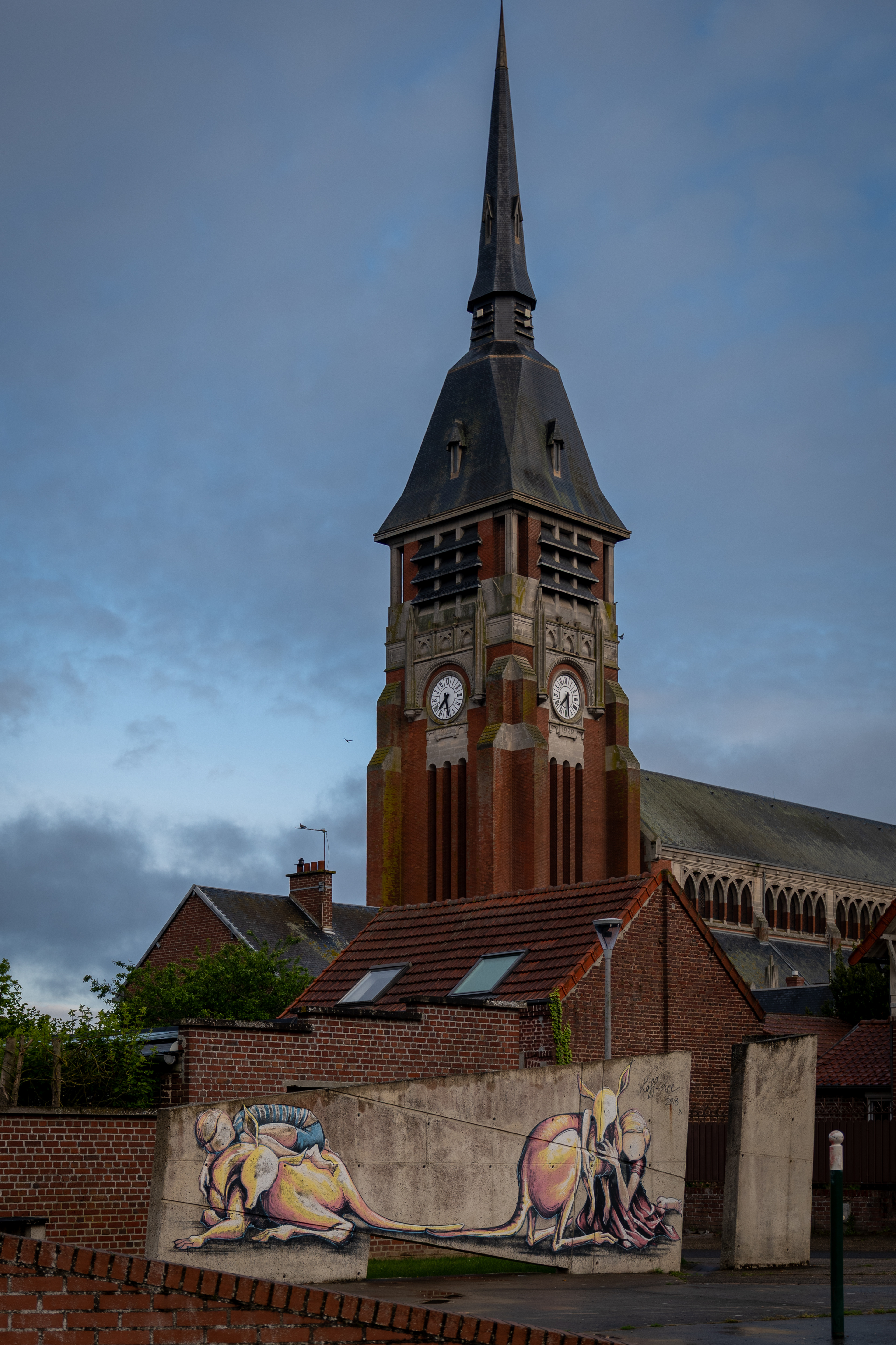The Cushion Me / Shelter Me mural showing the reciprocal relationship between Australia and Villers-Bretonneux by Australian street artist Kaff-Eine, 2013, painted in the town square with the church visible behind, Villers-Bretonneux, France, May, 2026. Photo: Jon L Arthur