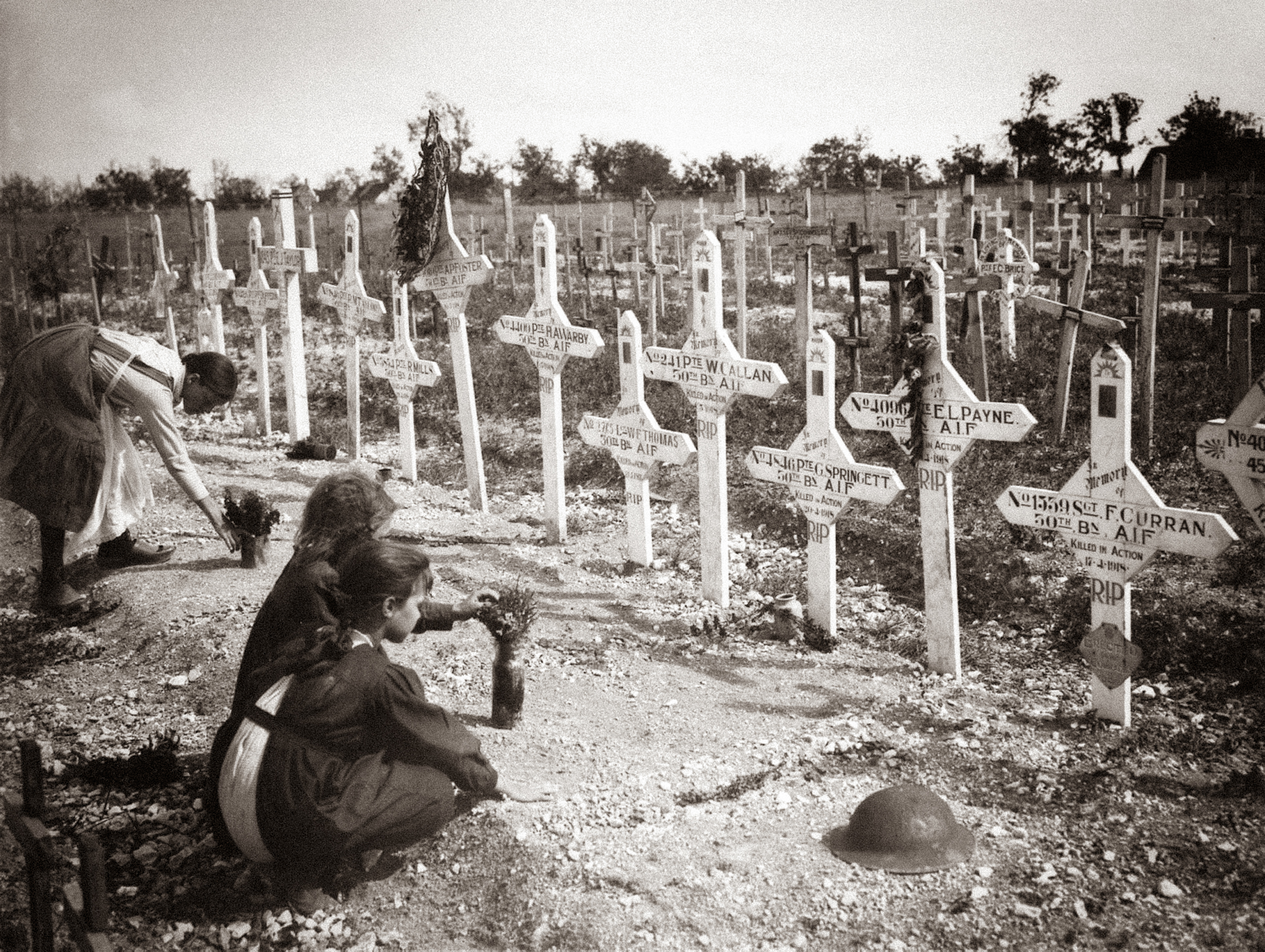 Reproduction of a period photograph showing French civilians tending the graves of Australian soldiers at Adelaide Cemetery, Villers-Bretonneux, France, c.1918–1919. Photographed in situ at the Musée Franco-Australien, Villers-Bretonneux, 2026. Photo: Jon L Arthur.
