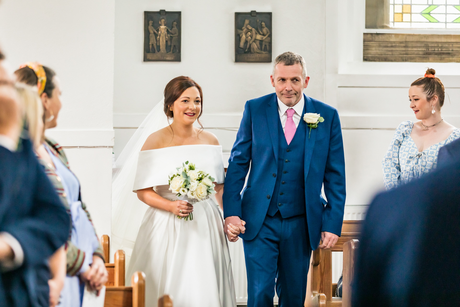 A bride walking into church on her wedding day in Ambleside, Cumbria