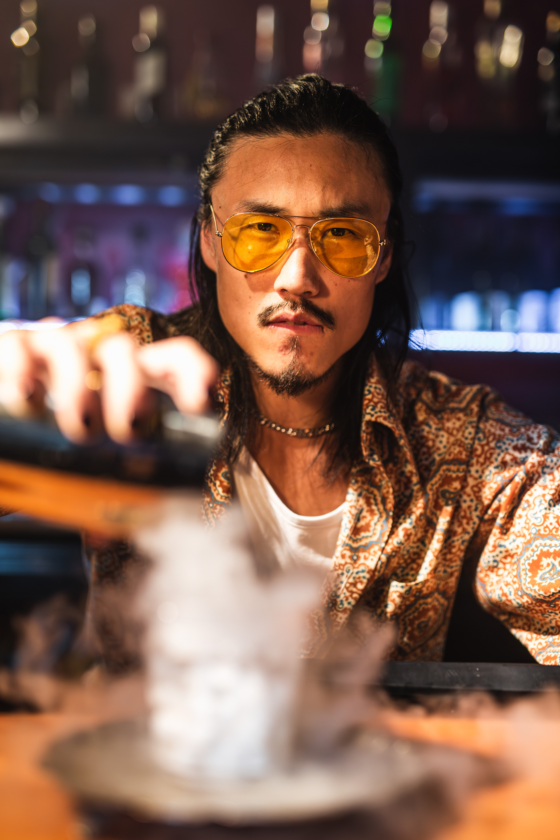 Tian Tan as "Jin" mixing a drink at his bar "The Dragon's Dojo", photo by Ankita Singh 2023