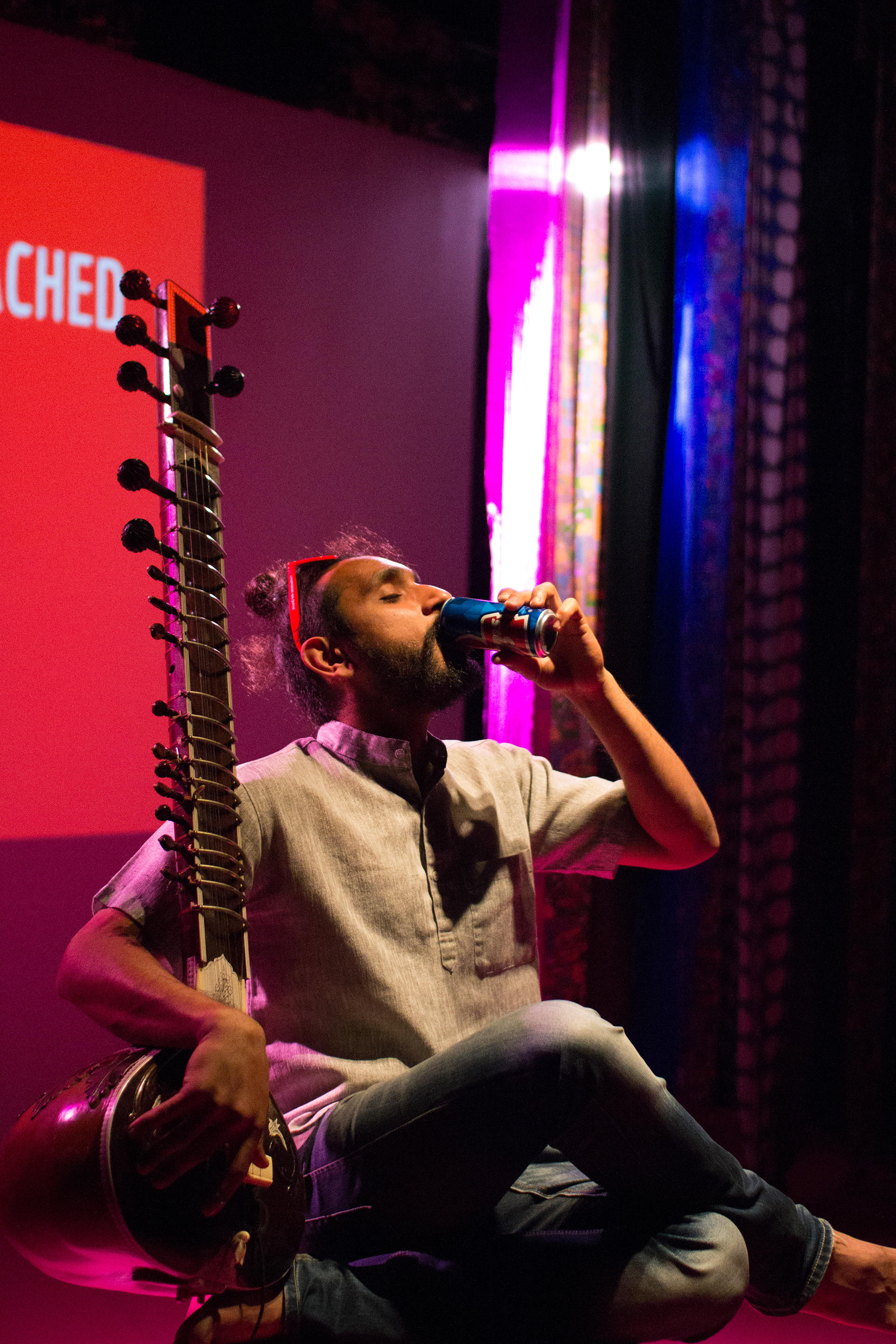 Dhruv Mody drinking a can of Thumb's Up during his piece "No Strings Attached", photo by Ankita Singh 2018