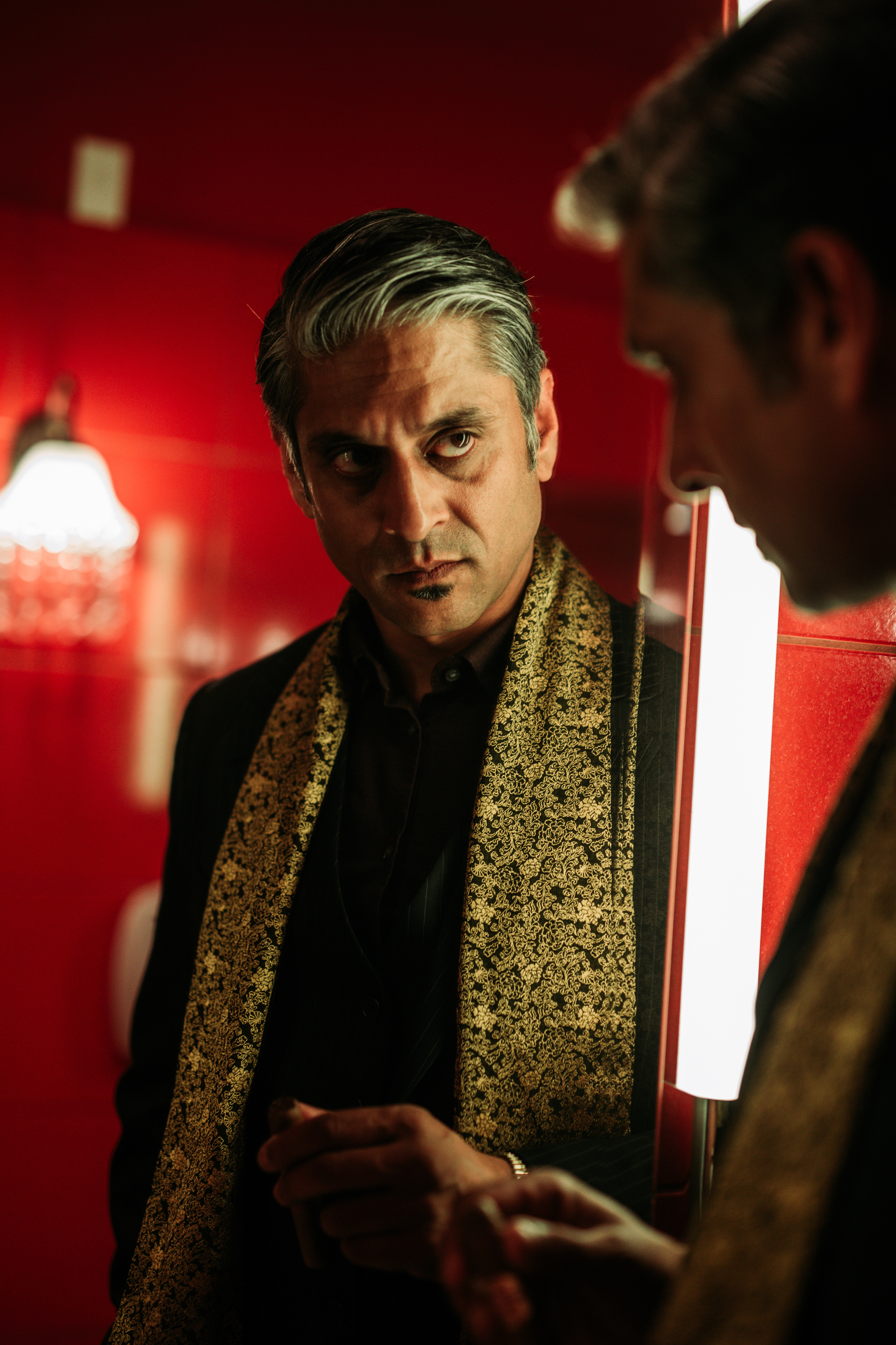 Mel Odedra as Toby "The King" looking at his reflection in the mirror, photo by Ankita Singh 2023