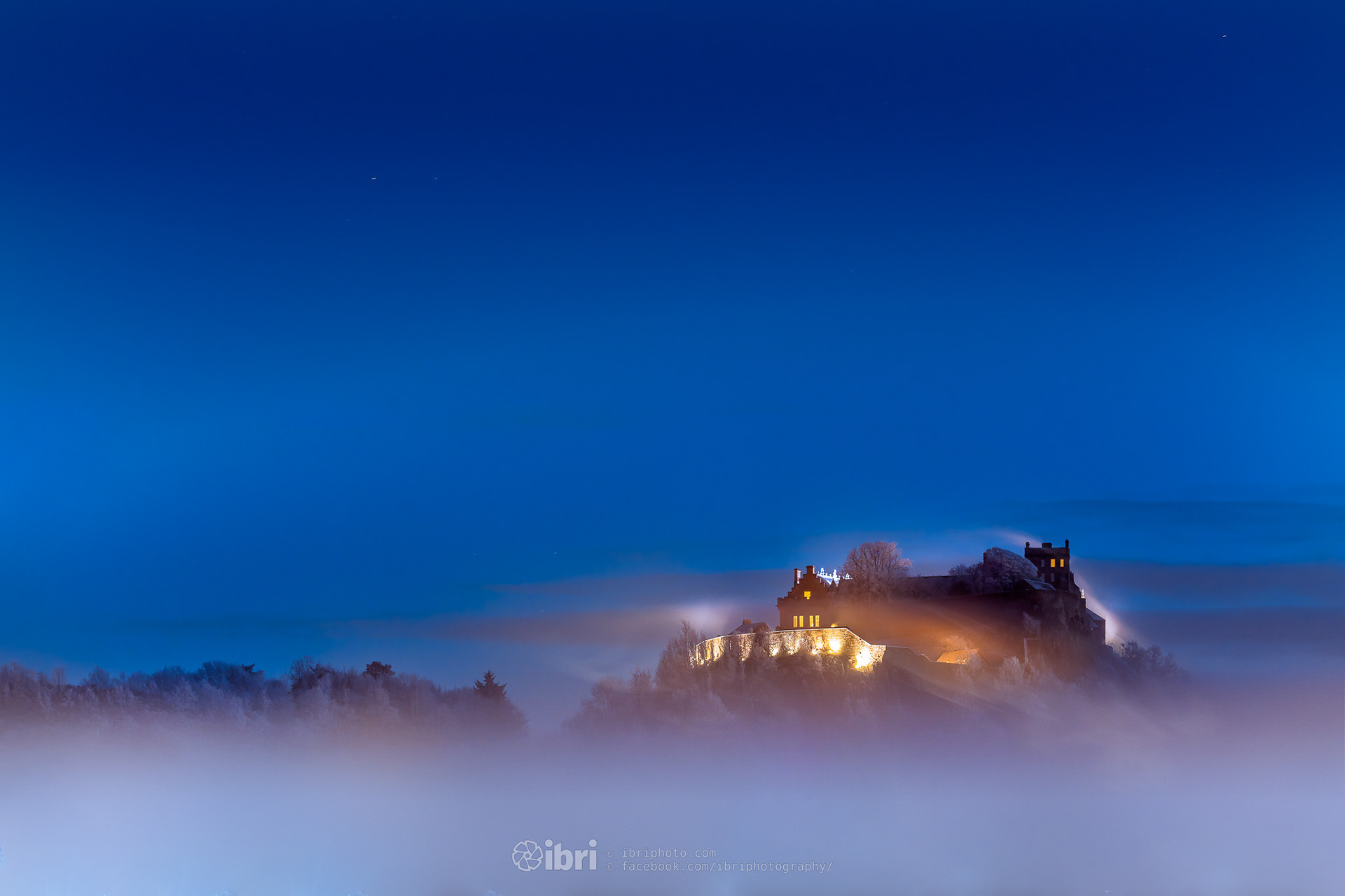 With some basic edits in Lightroom, then into Photoshop for tweak or two (brushed in some more fog and mist, removed some of the distractions, and switched a few more window lights on.