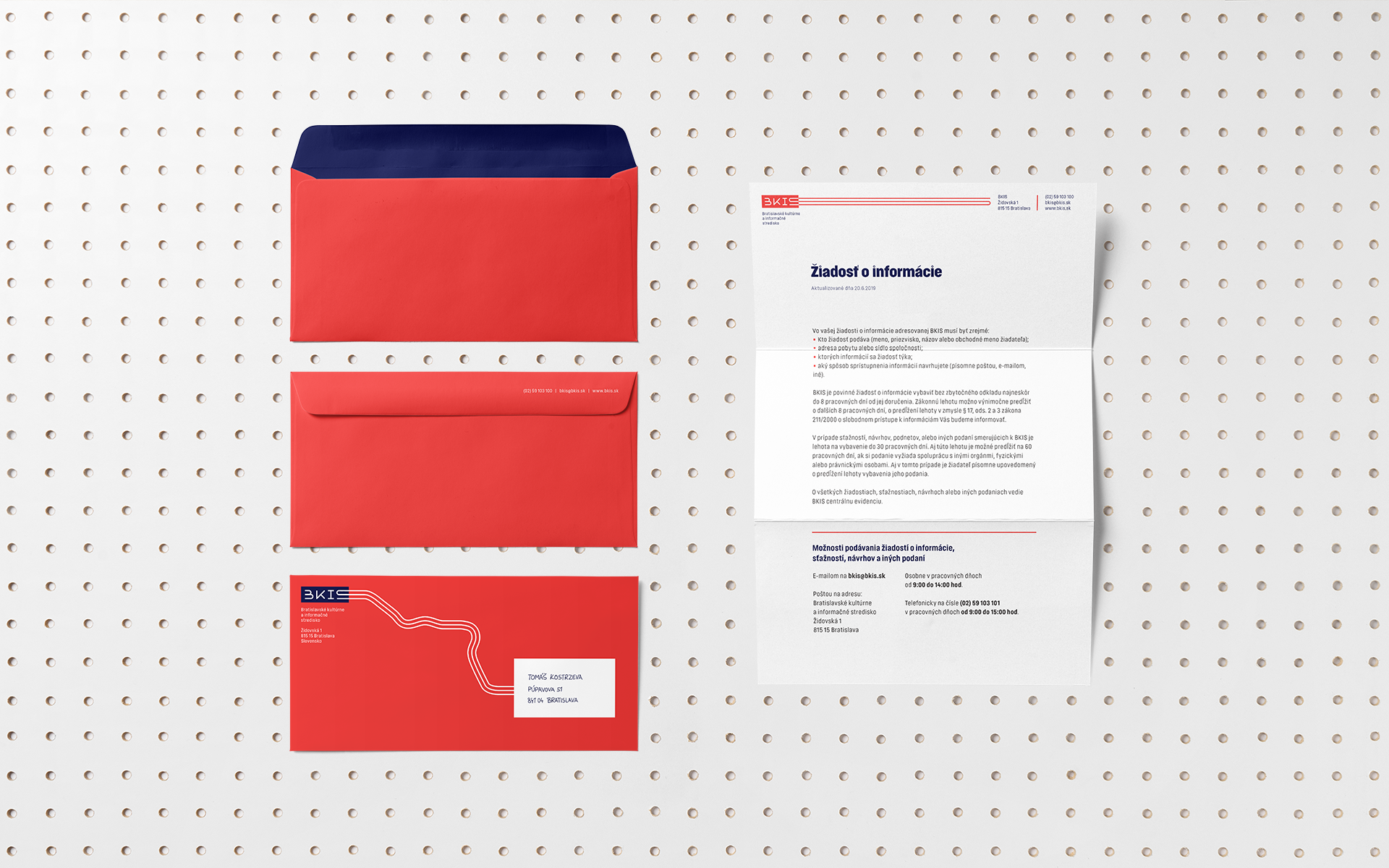 BKIS stationery proposal visual identity. Red envelopes with Danube pattern with letterhead, over the wooden dot background