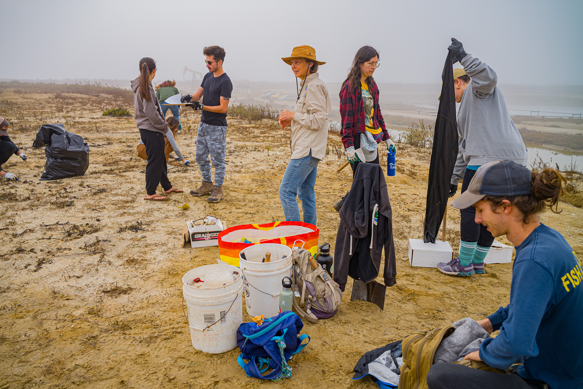 Volunteers from Re:Wild and Bolsa Chica Land Trust grab bags and gloves to remove plants from the island. They need to make room for the California Least Tern and Snowy Plover species of birds to nest.  Photo Credit: Justin Enriquez