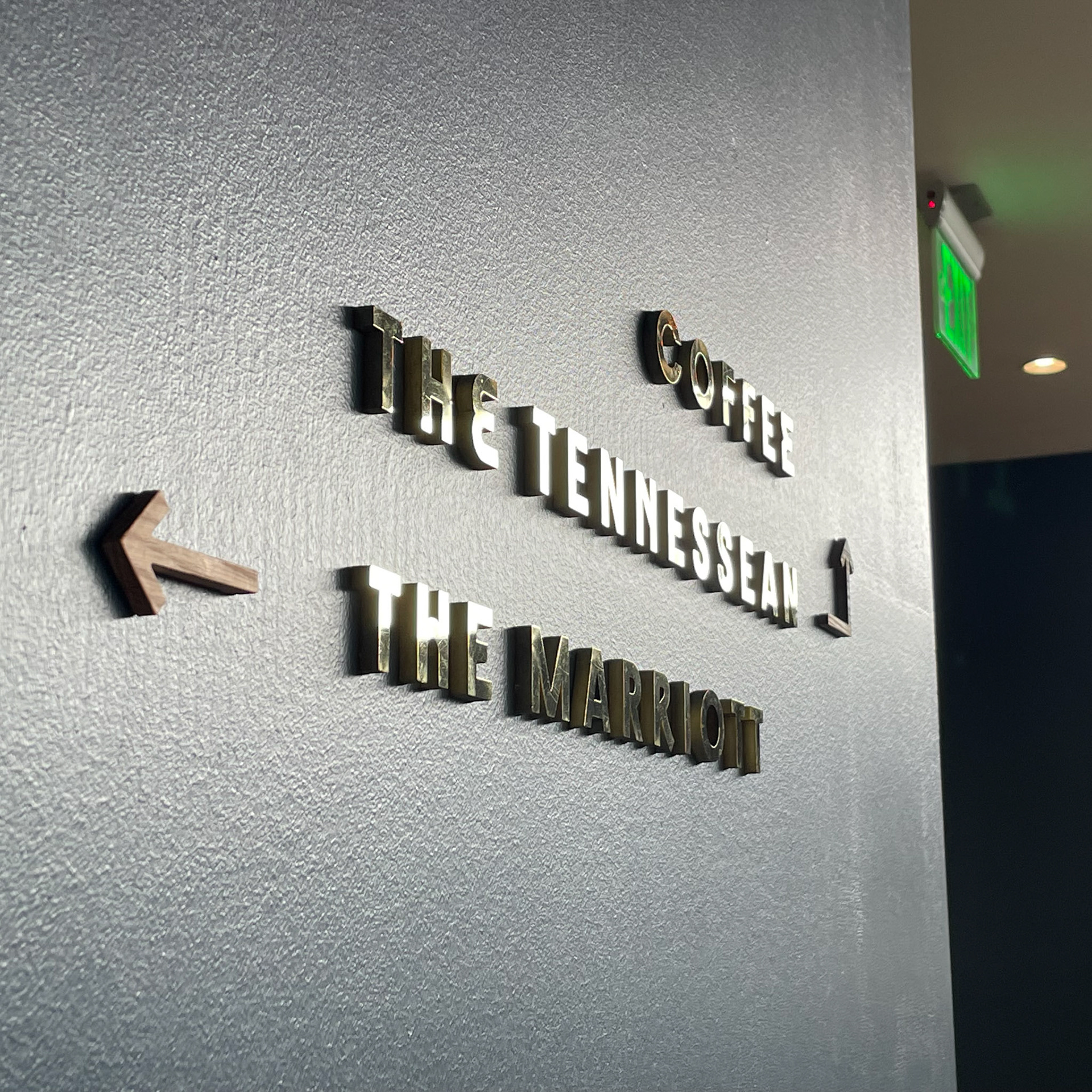 solid brass and white oak wayfinding