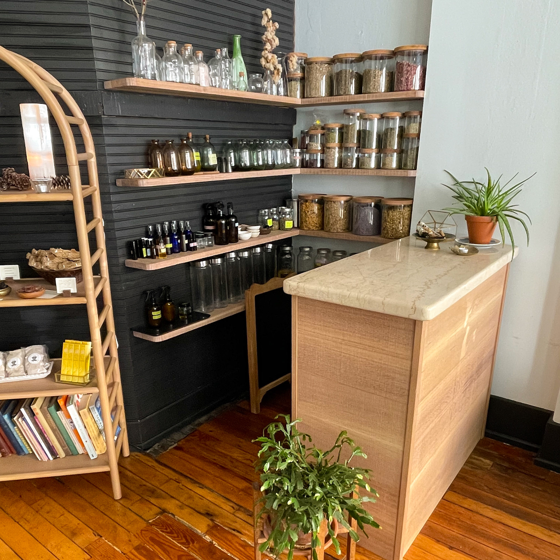 apothecary with floating shelving and white oak and granite cabinet