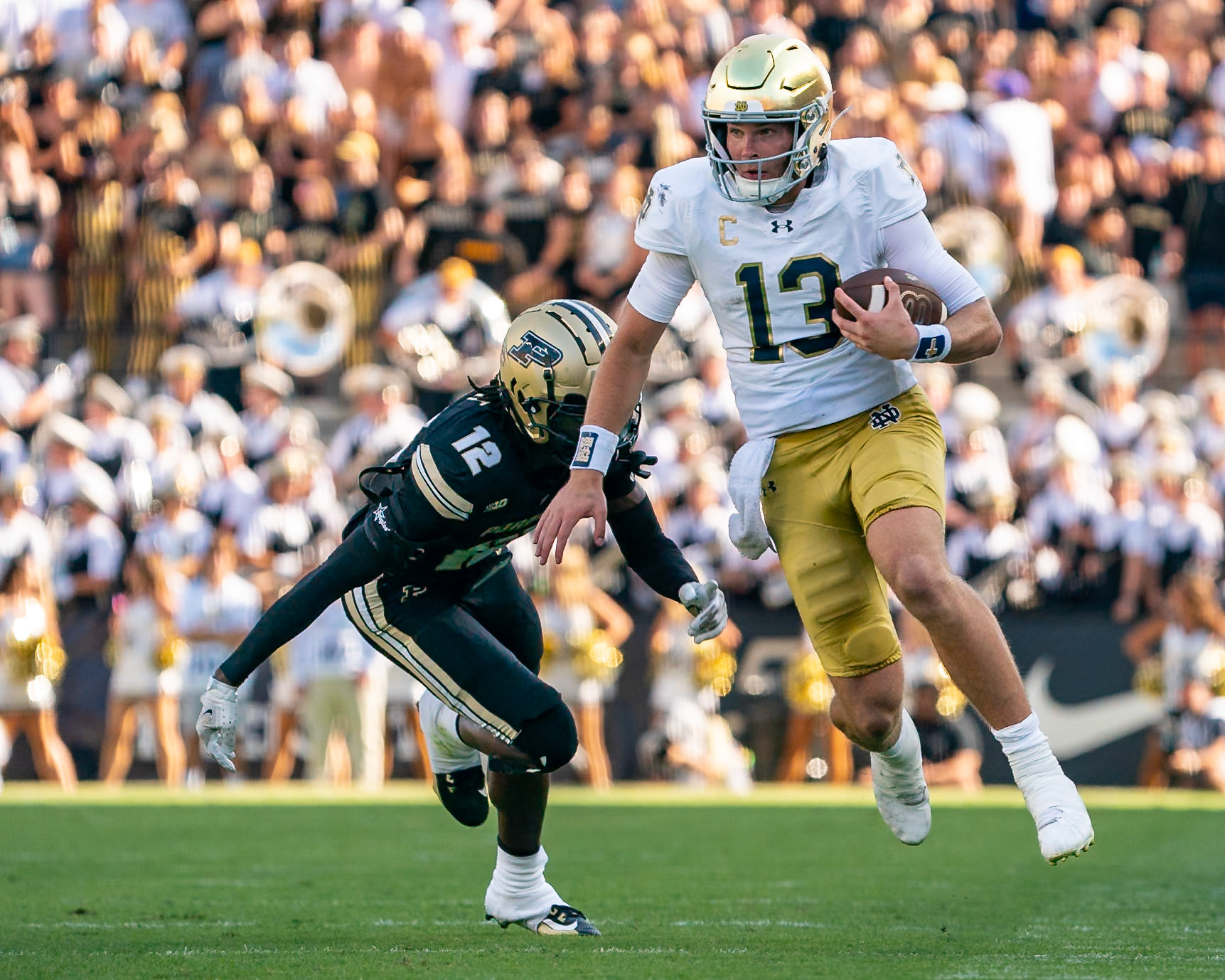 WEST LAFAYETTE, IN - SEPTEMBER 14, 2024: Notre Dame Senior QB Riley Leonard (13), Purdue Fr. Defensive Back Tarrion Grant (12) during the Purdue University Boilermakers vs Notre Dame Fighting Irish Football game at Ross-Ade Stadium(Photo by Steve Bowen / Bowen Arrow Photography / Northern Indiana Sports Report)