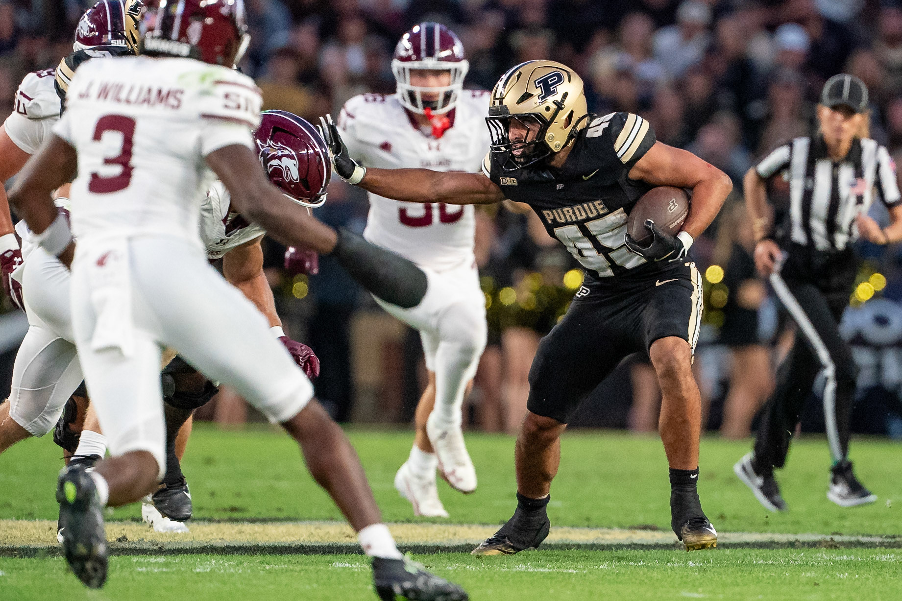 WEST LAFAYETTE, IN - SEPTEMBER 6, 2025: Purdue University Senior Running Back Devin Mockobee (45) putting out a stiffarm at Purdue Boilermaker Football vs Southern Illinois Saluki Football at Ross-Ade Stadium(Photo by Steve Bowen / Northern Indiana Sports Report)