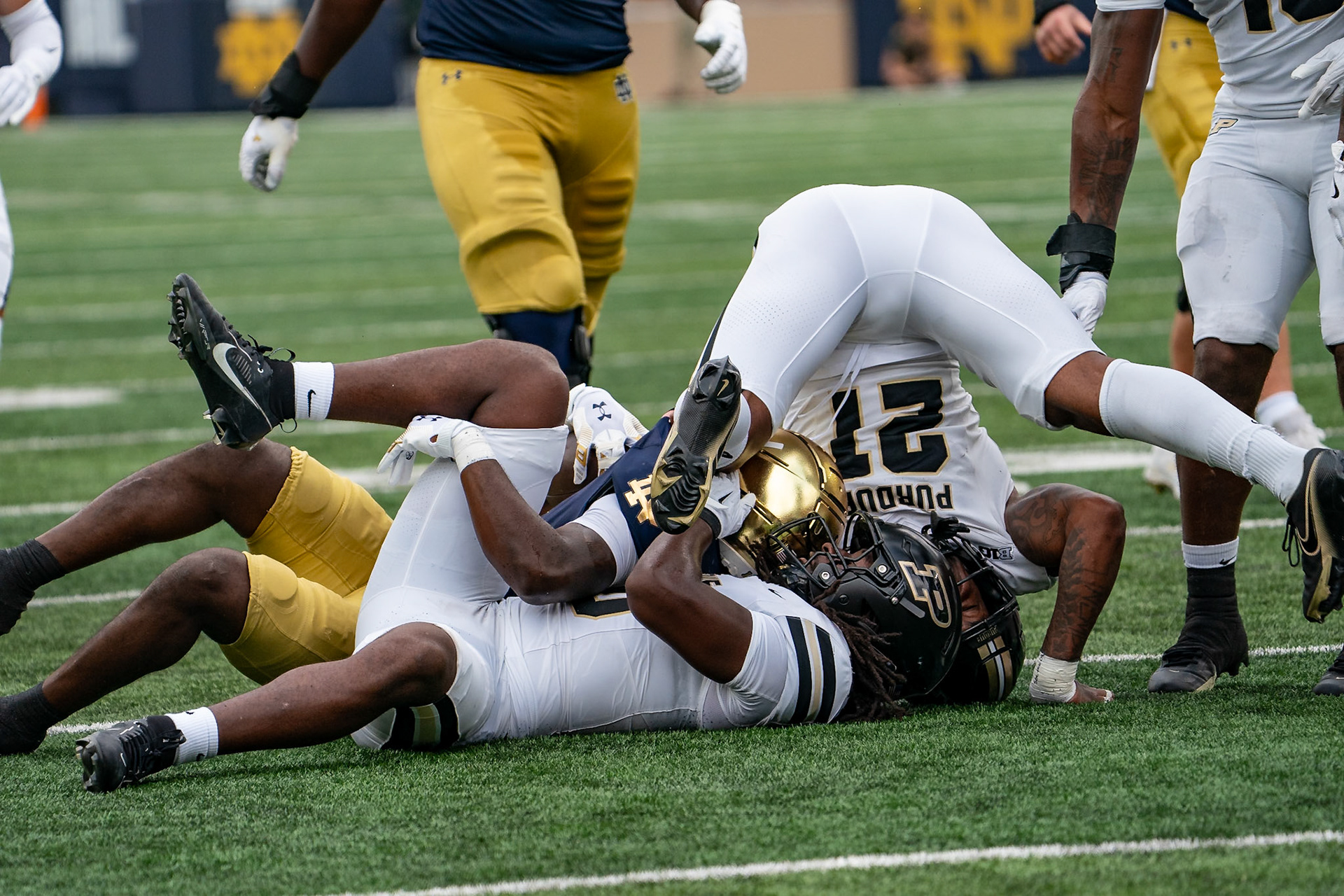 SOUTH BEND, IN - SEPTEMBER 20, 2025: Notre Dame University Junior RB Jeremiyah Love (4) taken down by Purdue University Junior Linebacker Alex Sanford Jr. (10) and Purdue University Senior Defensive Back Tahj Ra-El (21) in Purdue Boilermakers at Notre Dame Fighting Irish Football at Notre Dame Stadium(Photo by Steve Bowen / Northern Indiana Sports Report)