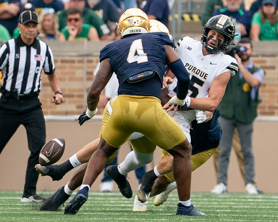 SOUTH BEND, IN - SEPTEMBER 20, 2025: Purdue University Sophomore Quaterback Ryan Browne (15) takes a buig hit from Notre Dame University's Sophomore DL Boubacar Traore (5) and drops the ball as Notre Dame University's Sophomore LB Jaiden Ausberry (4) looks on during the Purdue Boilermakers at Notre Dame Fighting Irish Football at Notre Dame Stadium(Photo by Steve Bowen / Northern Indiana Sports Report)