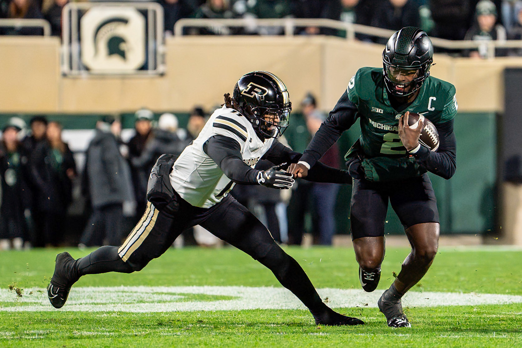 EAST LANSING, MI - NOVEMBER 22, 2024: Michigan State University Quaterback Aidan Chiles (2), Purdue University Senior Defensive Back Antonio Stevens (11) in Purdue University Boilermakers at Michigan State University Spartans Football game at Spartan Stadium(Photo by Steve Bowen / Bowen Arrow Photography / Northern Indiana Sports Report)